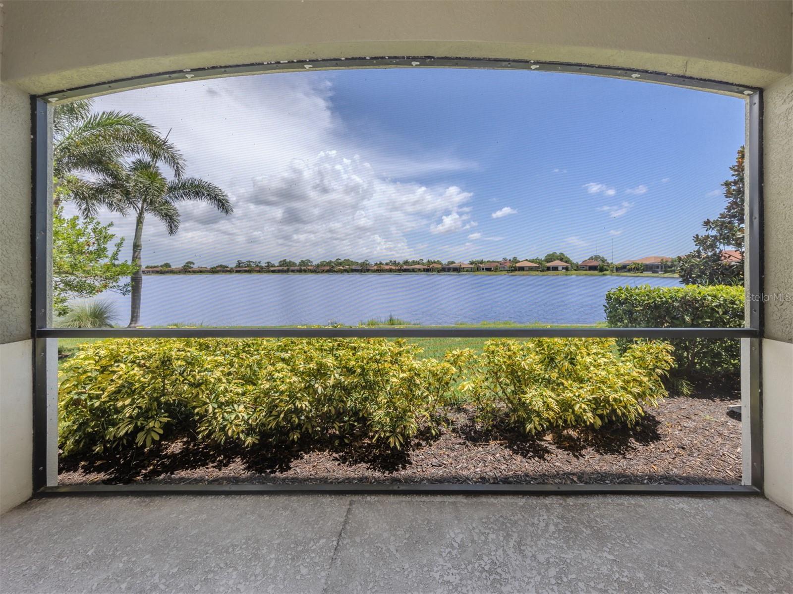 Welcome to the beautifully designed, resort-style gated community of Toscana Isles in the heart of North Venice! Go inside and you will fall in love with this beautiful 1,398-square-foot, long lake view first-floor condominium offering two spacious bedrooms, two modern baths, versatile den/flex room, and private one-car garage. The screened front porch is welcoming to guests and complements this home. Enter and find an open and airy space with tall ceilings and many modern conveniences. The kitchen includes a breakfast bar, opaque 42-inch cabinetry, granite countertops, stainless steel appliances, lots of storage, and eat-in space making this a chef's dream. The kitchen overlooks the large great room and boasts sliding glass doors that leads to the screened-in lanai with amazing water views. The den/flex room is just off the great room and could easily double as an office or craft space. The primary bedroom at back of the home for the most privacy includes a custom walk-in closet, beautiful water views, and private en suite, making this an owner's paradise. The second bedroom is down the hall at front of the home with a walk-in closet and in proximity to the second full bath, making this the ideal split set up. The laundry closet is in the hallway making this chore convenient for the unit. Throughout this unit, as an added bonus you will find a built-in sprinkler system, smoke detectors and hurricane protection for added peace of mind. With soaring ceilings and tranquil lake views, you will fall in love with this first-floor condominium in the heart of Venice! Enjoy the convenience of an oversized one-car garage which offers plenty of extra space for a vehicle and storage. Toscana Isles is resort style designed to live every day like you are on vacation and includes an over 8,000-square-foot amenity center with a resort-style infinity-edge pool, state-of-the-art fitness center, pickleball courts, playground, activities room, tennis and bocce courts, a large fire pit and dog park. Residents are also permitted to go fishing, kayaking, and canoeing on more than 200 acres of ponds in the community. Just a few miles from tranquil Gulf beaches, quaint downtown Venice, Cool Today Braves spring training ballpark, new Sarasota Memorial Hospital, A-plus rated schools, downtown Wellen Park, Interstate 75 and U.S. 41.
