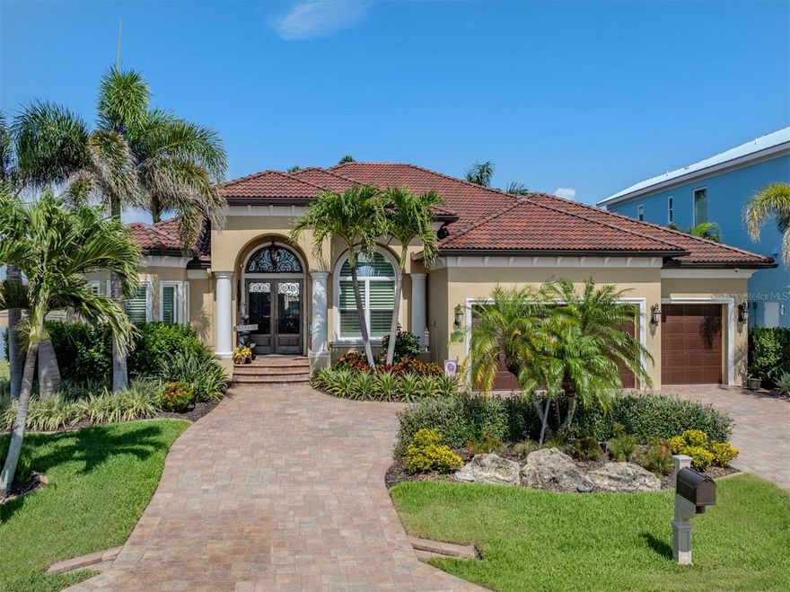 Punta Gorda Isles! TURNKEY! Exquisite 3 bedroom + office, 2.5 bath, 3-car garage waterfront pool home custom-built by West Coast Builders! True western exposure to enjoy beautiful sunset views across Vivante Lake! This magnificent home has been recently redecorated with high end furnishings and rich architectural details including marble floors thru-out, coffered ceilings, elegant lighting and fixtures, electric remote-controlled shades in living and dining room, media center w/Samsung 65" Qled TV and surround sound music thru-out the entire home. Custom gourmet kitchen features high end appliances including Monogram induction cooktop however propane gas is available, designer wood cabinetry, generous breakfast bar and boasts newly added large Butler’s Pantry with wine bar. Luxurious primary suite is a sanctuary to behold and offers private ensuite with 36" flat screen TV behind the mirror, garden bath and Roman shower. A private hallway leads to two spacious guest bedrooms and separate stylish bath. Step outside to your private oasis featuring covered lanai, amazing outdoor kitchen and custom heated salt water pool and spa w/pool bath-perfect for entertaining guests. For ultimate peace of mind, seller has added new Brava tile roof, 2023 (20yr. tested to 200mph), new (2025) 22KW whole house generator with entire home pre-wired and automated to light your favorite art works, advanced security, video and automation, in and out, 10’ concrete seawall plus home features impact windows and doors and transferable flood policy. Additional seller upgrades include new variable-speed pool pump and heater (2024), new central silent vac, water leak sensors thru-out will shut off main and alert your phone, newly painted exterior and trim (15 yr), air-conditioned garage with new custom cabinets and shop area, newly epoxied garage floors and stunning professional landscaping surrounds the property. Quiet street with no boat noise and within walking distance to Ponce De Leon Park with a beautiful small beach and boat launch. Minutes to Isles Yacht Club, Fishermen’s Village, world-class fishing and boating and downtown historic Punta Gorda with community events and entertainment. This stunning home is the perfect Florida retreat or permanent residence! Schedule your private showing today!