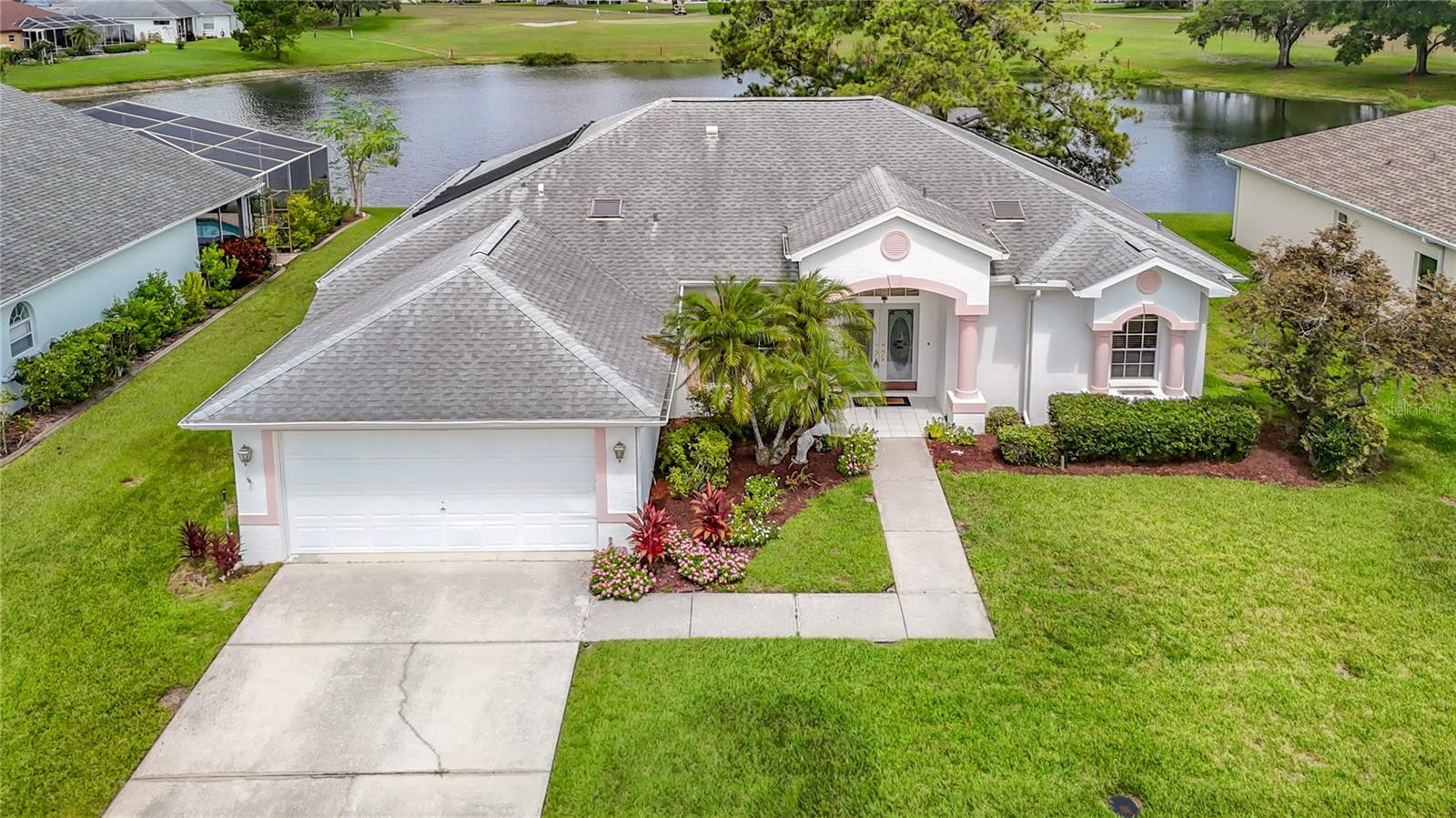 Make this home your own Florida Paradise – Enjoy, a HEATED SWIMMING POOL, LAKEFRONT, GOLF COURSE VIEWS! Meadow Oaks Golf and Country Club is a hidden jewel located in the Greater Tampa Area. This one-of-a-kind, premium lot boasts a picturesque setting with beautiful views of the lake and golf course. From the moment you step inside you’ll embrace the bright and airy feel of the home with its 10-foot ceilings! Enjoy the BREATH-TAKING LAKE VIEWS! It's numerous windows and 3 SETS OF GLASS SLIDERS which allow natural light to flood into the home and invites seamless indoor-outdoor living! CUSTOM WOODWORK provides a touch of elegance, including CROWN MOLDING in main living areas, ornate built-in cabinets in the dining room and dinette, and beautiful sunburst shutters in front arched windows! Preview an open floor plan that features a kitchen with stainless steel appliances (new 2023) and a breakfast bar that opens to the living area. The cozy breakfast nook SURROUNDS YOU IN WINDOWS OVERLOOKING THE LAKE! The split bedroom plan allows privacy for all. The primary suite offers glass sliders to enjoy daily sunsets. Two additional spacious bedrooms and a convenient POOL BATHROOM provides convenience for guests. An INSIDE LAUNDRY ROOM off the kitchen adds practicality. Outdoor living takes center stage - imagine diving into the pool with its cascading waterfall on a hot sunny day, lounging in your hammock, or spending your evenings quietly relaxing poolside with your umbrella drink, as you watch the water birds return to roost against the stunning backdrop of the Florida sunset! The solar pool heating offers YEAR-ROUND SWIMMING. The screened lanai and backyard oasis provides plenty of room for entertaining, an ideal setting for outdoor grilling and playing games! Poolside extras include outdoor poolside shower, and poolside kitchen complete with a sink and grill. Extras include new exterior paint, complete hurricane window and door fabric protection, pool resurfaced 2022, Roof 2017, AC 2018! Plus, the irrigation system ensures easy lawn care, so your outdoor space stays beautiful year-round. This is a vibrant neighborhood featuring clubhouse amenities including an Olympic size pool, pickleball, tennis, basketball, shuffleboard, fitness center, billiards room and the clubhouse social event calendar. Golf community and club house with pro-shop and café which serves the public. Hop on your golf cart and explore the scenic surroundings. For a low HOA $52 fees and no CDD fees, you get the benefits of resort-style living! Conveniently located just minutes from the Veterans Expressway, this home offers easy access to Florida’s beautiful sandy beaches, downtown Tampa & St Pete, and Tampa International Airport! Schedule your visit today and make Meadow Oaks your forever home!