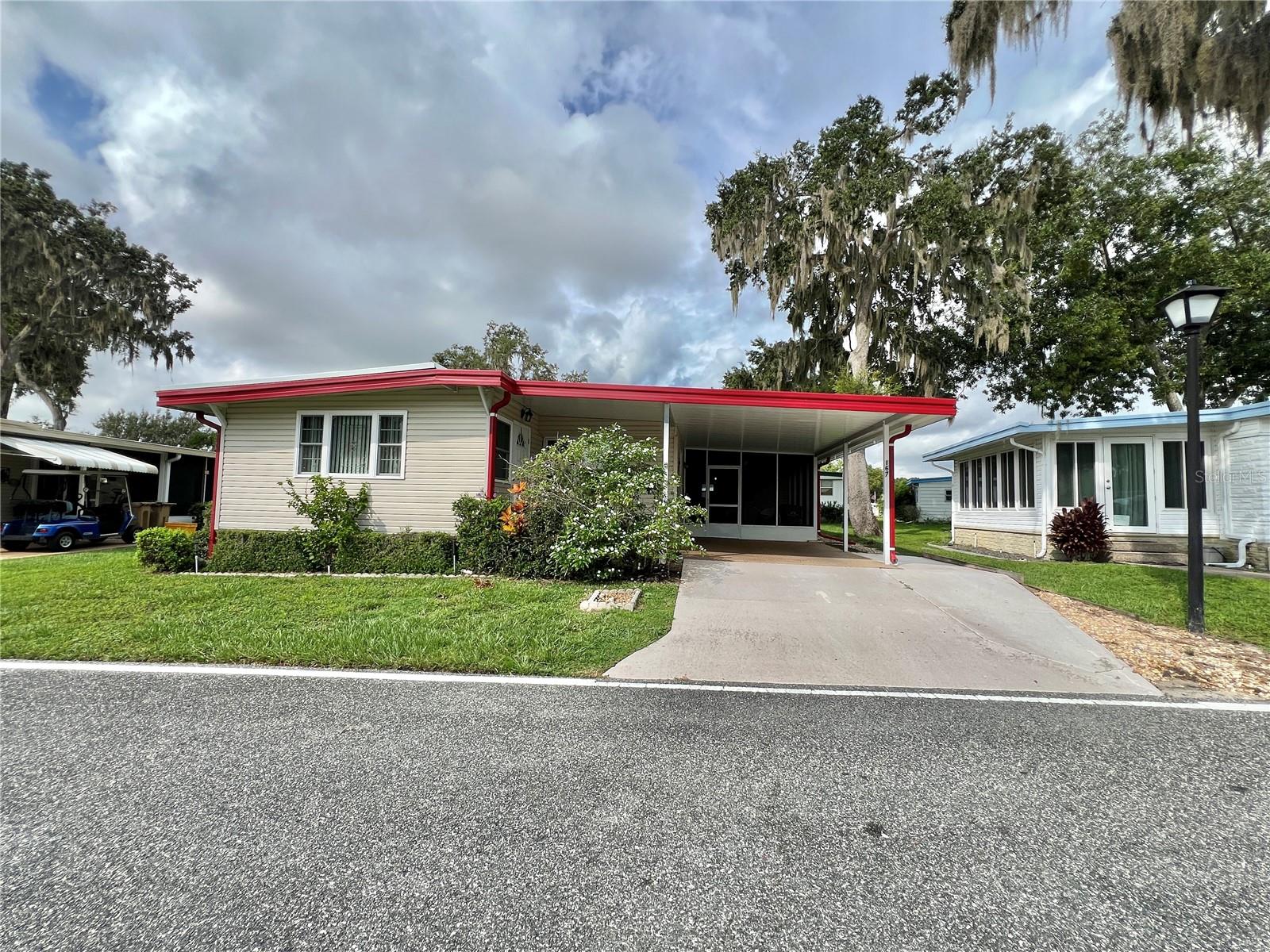 Turnkey & Tastefully Updated Residence in Sought-After Azalea Trail.
Step into effortless Florida living with this fully furnished 1,302 sq. ft. home, brimming with thoughtful enhancements and long-term peace of mind. Boasting a 2015 main roof and brand-new 2024 roofing over the Florida room and carport, this property exemplifies smart ownership and care.
Inside, you’ll find luxury vinyl plank flooring atop new subfloors (2020), creating a cohesive and durable foundation. The well-appointed kitchen features a peninsula layout ideal for entertaining, pull-out cabinetry, and a full suite of modern appliances. Upgraded windows invite natural light while enhancing energy efficiency.
Both bathrooms have elegant walk-in showers, and multiple ceiling fans ensure year-round comfort. A spacious screened room (10’ x 20’), added in 2005, and an enclosed utility space (12’ x 6’ x 4.2’), added in 2010, provide versatile functionality. The home is clad in vinyl siding and accessed via a P-gravel driveway, combining low maintenance with curb appeal.
Whether you’re downsizing, wintering, or seeking a serene year-round retreat, this meticulously maintained home is an exceptional find.
...........Hawthorne at Leesburg is an active, resident owned, 55+ cooperative, waterfront, gated community, with beautifully landscaped grounds, lakes with illuminated fountains and a relaxing and comfortable gazebo. The affordable monthly maintenance fee of $346 includes water, sewer, lawn mowing, private emergency services and storage space for recreational vehicles, boats, trailers and much more! The beautiful clubhouse is complete with a full-time program coordinator, more than 100 different activities and seating for 550. It has a hospitality lounge, card rooms, craft rooms, billiard room, fitness center, library, fine arts room and many more. There is excellent fishing, outdoor geo-thermally heated pool and two enclosed therapeutic pools. Hawthorne boasts a private marina monitored by an electronic security system with over 120 boat slips and access to the Harris Chain of Lakes and beyond.