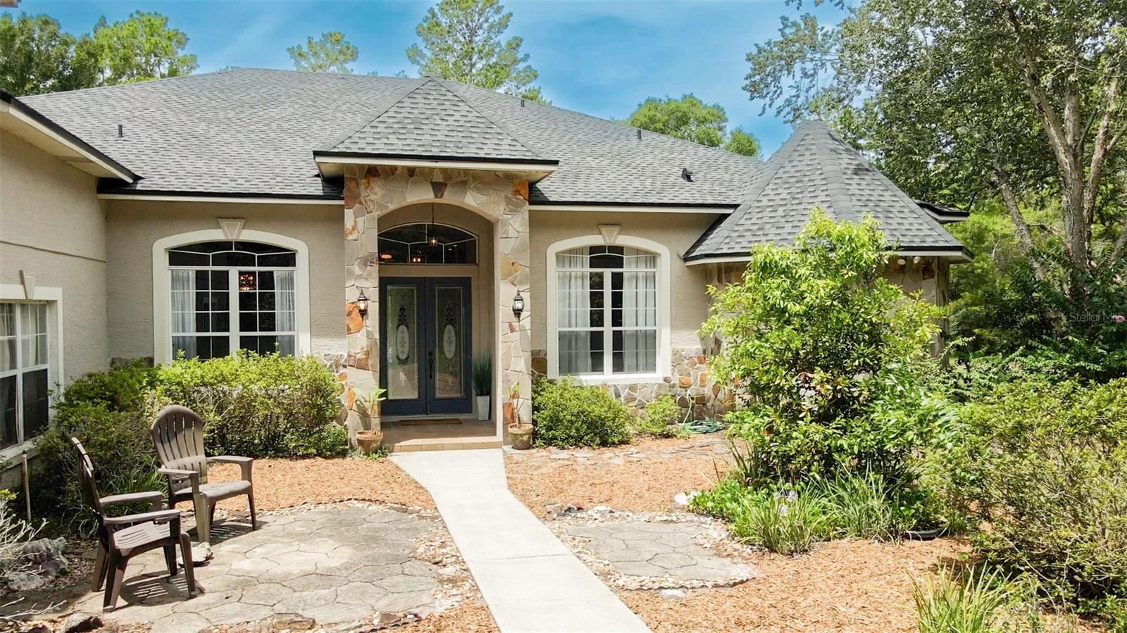 Welcome to 700 Valley Stream Drive - this thoughtfully designed 4-bedroom, 4-bath, 3-car garage custom-built pool home nestled on over 5 high-and-dry wooded acres in the highly sought-after guard-gated community of Seminole Woods. This home offers a fantastic floorplan and sits on an exceptional lot—a true canvas ready for your personal touch! Step inside to a spacious foyer with soaring 12’ volume ceilings, abundant natural light, crown molding throughout, and oversized French doors framing a picturesque view of the pool and spa area. The stone fireplace adds a touch of elegance to the living area, creating a cozy yet refined atmosphere. This home features a three-way split plan, providing privacy and flexibility for your everyday living or guests. The owner’s suite is a true retreat—generously sized and thoughtfully designed for both comfort and flexibility. It features its own cozy fireplace, French doors leading to the pool area, and a private exterior entrance—perfect for creating a separate office, studio, or even a private living space. The ensuite bath is expansive, offering a garden tub, separate walk-in shower, dual vanities, and ample counter space, making your morning routine a breeze. The kitchen is the heart of the home boasting a generous footprint, walk-in pantry, and ample counter space. The large indoor laundry room offers room to build out the ultimate drop zone or organizational area. The downstairs secondary master suite with private entrance, and a dedicated office space open up endless possibilities. Additionally, the remaining bedrooms offer a jack and jill bathroom area. Upstairs the oversized bonus room could house a theater, additional bedroom, office area or whatever your heart desires. Outside, the screened covered lanai is pre-plumbed for an outdoor kitchen, opens to the spacious pool and spa, a full pool bath and has a convenient outdoor shower area. Enjoy your mornings and evenings on the pool deck or in the gazebo taking in all that nature has to offer. With plenty of open space, there’s room to build your dream workshop, barn, or store your boat, camper, or ATVs. Seminole Woods is Central Florida’s best-kept secret, offering 13 miles of private equestrian and walking trails and a lakeside community park on skiable Buck Lake. Enjoy access to a private boat ramp, beach, pavilion, basketball and volleyball courts, playground, gazebo, firepit, and more. Whether you're looking for a private retreat, a place to play, or a home to make your own, this property is a rare opportunity to create something truly special. Bring your vision and design inspiration to transform this diamond in the rough into your dream estate. Don’t miss out—call today to schedule your private showing!