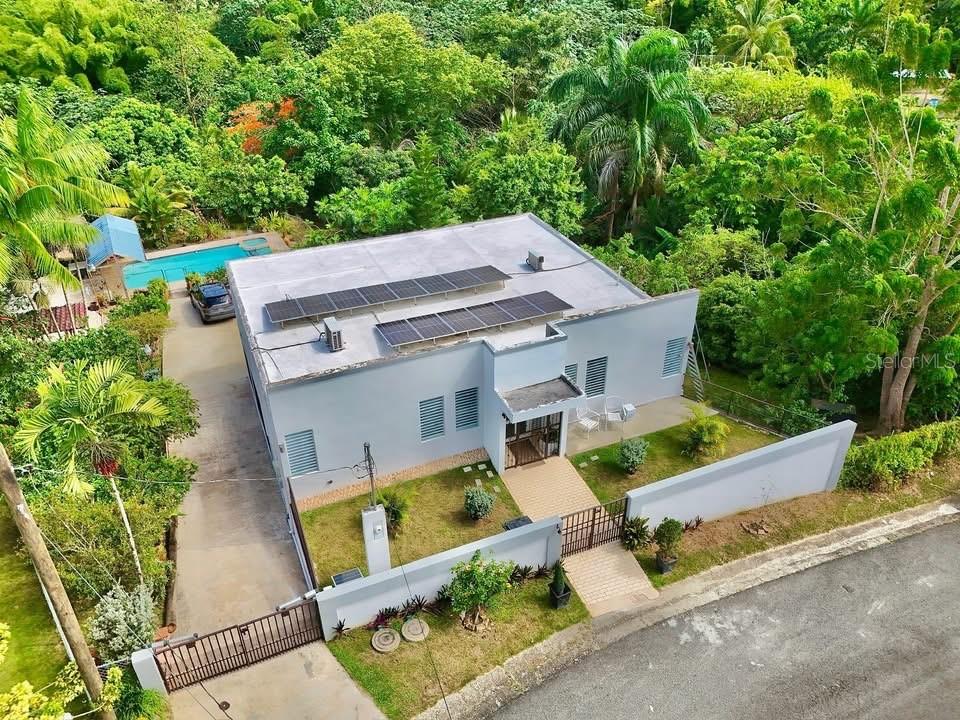 Recently appraised and located in Sect. La Changa of Caguas, PR, this charming property offers an ideal combination of spaciousness, comfort, and functionality in a setting surrounded by nature. The residence has been enhanced with valuable upgrades, including a fully-equipped solar system, a cistern, and a recently remodeled kitchen and laundry area. The property also boasts more than 10 fruit trees that add freshness and character to the space. The property includes air conditioners, a refrigerator, a stove, a washer, and a dryer, making it a move-in ready option. For those interested in generating income, the property can be divided into two independent units, making it perfect for short- or long-term rentals. A unique opportunity in a quiet area of Caguas with excellent residential and investment potential. As an added bonus, it is located just two minutes from Highway 1, providing easy access to main roads.