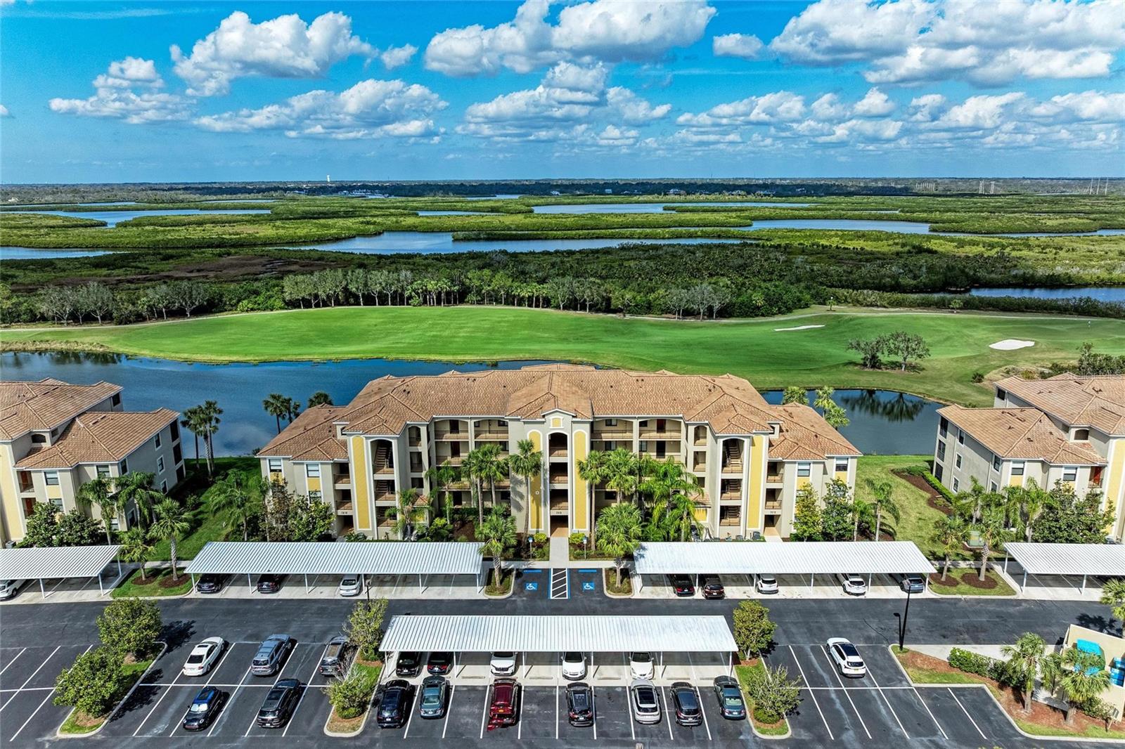 JUST REDUCED!! VALUE PRICED WITH ELEVATED STYLE makes this one truly special! TOTALLY TURNKEY, MOVE-IN READY and complete with beautiful furnishings and accessories, you will be able to envision this FIRST FLOOR condominium as your next primary residence, second home or investment opportunity! Everything you need is here to make this 2 bedroom, 2 bath GOLF DEEDED residence your next Florida home! Beautifully designed with custom paint and light fixtures, plantation shutters, and vinyl flooring, this unit was thoughtfully furnished with a stylish yet functional design. The eat-in kitchen is spacious, with custom backsplash, painted cabinets and breakfast bar leading to the combined dining and great room space. Sliders open to the private no-seeum screened lanai and the SPECTACULAR GOLF AND WATER VIEWS that River Strand is known for! Southern exposure also means gorgeous sunsets, sunrises and Florida sunshine year round! The primary suite enjoys the vistas too and includes 2 walk-ins and en-suite with painted cupboards. Complete with a nice storage room and assigned covered carport, it is all here. River Strand is a GATED RESORT COMMUNITY with 27 holes of Arthur Hills recently redesigned golf, clubhouse with RESTAURANT and grille room, 2 community pools and spas, tiki bar, 6 satellite pools, 2 fitness centers, tennis and pickleball courts and so many social and fitness events and activities! Ideally located minutes to I-75 and the new Marketplace and close to the beautiful beaches of the Gulf Coast! So come and see this special home in this exceptional community, once you experience River Strand at it's best you may never want to leave!