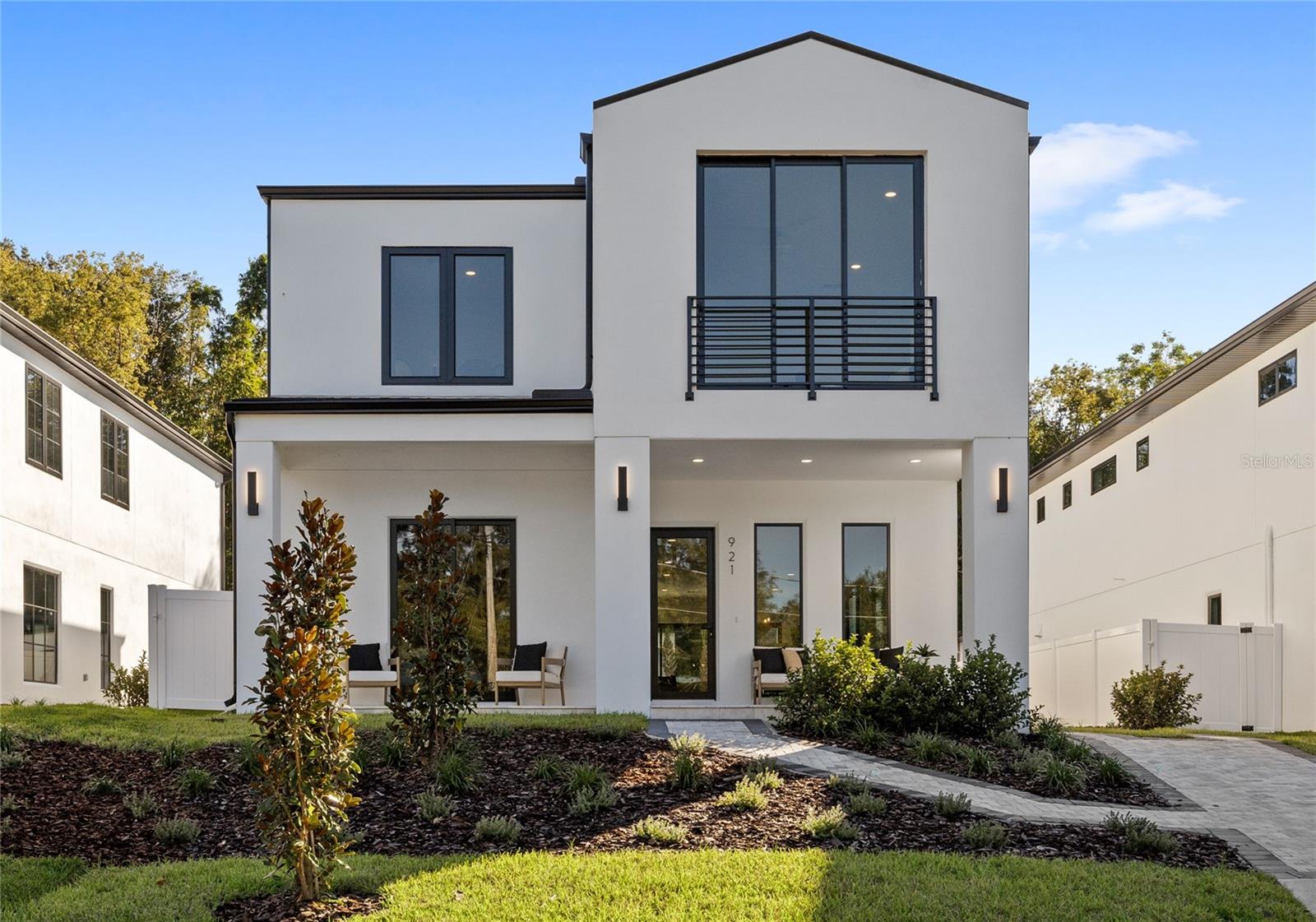 Welcome to 921 Lake Emerald Drive*-Zoned for Boone High, Howard Middle, and Lake Como Elementary, this rare luxury new construction home sits in one of Orlando’s most established neighborhoods.
While many homes in this area feature low ceilings and dated layouts, this residence redefines the standard blending modern design, soaring ceilings, and expansive natural light in perfect harmony.
From the moment you step inside, you’re greeted by breathtaking lake views that set the tone for a serene and elegant lifestyle. The living room, primary suite, and even the spa-inspired bath were thoughtfully oriented to capture the stunning front-lake panorama, offering an ever-changing canvas of colorful sunsets and Florida’s natural beauty.
The kitchen is a true showpiece, with a massive waterfall island, quartz counters, soft-close cabinetry, gas cooktop, wine fridge, and built-in bar. All curated with designer finishes. The layout was designed for real life, featuring a first-floor ensuite bedroom, guest half bath, and a large lanai ideal for entertaining.
Upstairs, you’ll find three additional bedrooms, a comfortable loft, and a spacious primary suite with dual dream walk-in closets and a spa-like bath that overlooks the tranquil water.
Step outside through the dramatic pocket slider to your private fenced backyard, complete with a stunning pool and a two-car garage-an absolute luxury in this part of town.
Located in the heart of SODO, you’re just minutes from Orlando Health, Downtown, and the city’s best local favorites, including 903 Mills Market and Kelly’s Ice Cream.
This is the kind of home that pairs the charm of an established neighborhood with the clean lines, open spaces, and thoughtful design of Luih Luxury Homes. Plus a front-row seat to some of the most unforgettable sunsets in Orlando.