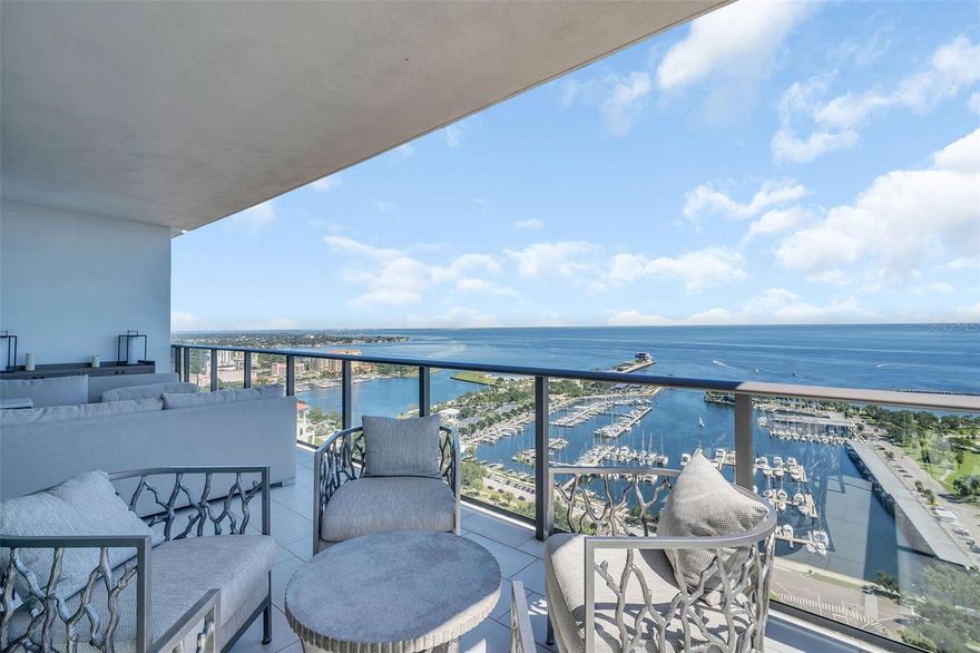 Perched high on the 30th floor, this stunning corner residence redefines elevated city living. Wrapping the coveted south corner of the tower, it showcases panoramic views that sweep from the tranquil blue waters of Tampa Bay to the glittering skyline and Gulf sunsets to the west.

Inside, discover a world of refinement and design excellence. The expansive open-concept layout features hardwood floors throughout, 10' floor-to-ceiling windows, and three private terraces that blur the boundary between indoor and outdoor living. The sleek European-inspired kitchen and contemporary finishes create a seamless backdrop for entertaining or relaxed evenings at home. The residence also includes a private, climate-controlled storage unit and two premium parking spaces with an electric vehicle charger.

Life at ONE St. Petersburg means access to the region's most impressive suite of resort-style amenities: a 40,000-square-foot elevated amenities deck with a 75-foot lap pool, private cabanas, spa, fire pits, outdoor kitchen, lush landscaping, and ample gathering spaces. Indoors, enjoy the Formal Social Room, Game Room, and Club Room, along with a state-of-the-art fitness and yoga center. A professional concierge, 24-hour security, and dedicated management team ensure a truly first-class living experience.

Positioned in the vibrant heart of downtown St. Petersburg, you're mere steps from Beach Drive's world-class dining, art galleries, waterfront parks, theaters, and boutiques. From sunrise over the bay to sunset over the Gulf, this is the ultimate expression of the downtown St. Pete lifestyle; luxurious, walkable, and effortlessly sophisticated.