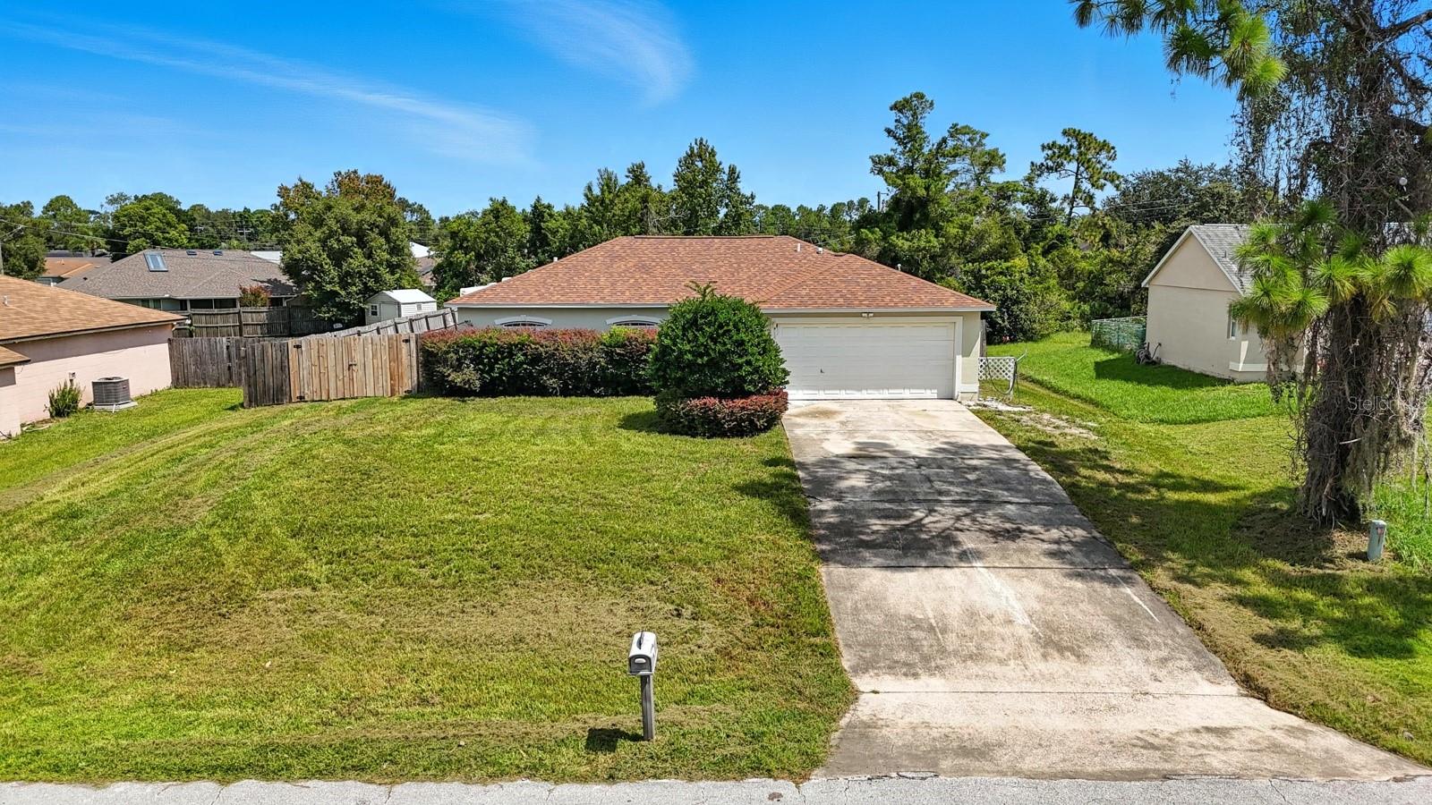 Welcome to this beautifully maintained 3 bedroom, 2 bath home in the heart of Deltona, Florida. Sitting high and dry on a lot that has never flooded, this property offers peace of mind along with modern upgrades, including a brand-new roof in 2023 and a new AC system in 2024. Step inside and you'll be greeted by an open and inviting living room with vaulted ceilings that create a spacious and airy feel. Fresh new carpet is being installed soon, adding a crisp and comfortable touch throughout the home. The kitchen and dining areas flow seamlessly into the living space, while sliding doors open to a screened Florida room, perfect for enjoying your morning coffee or entertaining friends in the evenings. The fully fenced backyard provides privacy and plenty of space for outdoor activities, gardening, or pets to roam freely. A two-car garage adds convenience and storage, rounding out the home's thoughtful features. This home is move-in ready and waiting for its next owner to enjoy. Don't miss your chance to make it yours schedule your private showing today!