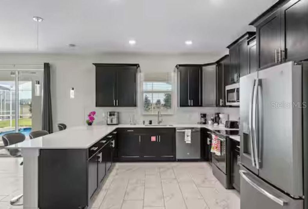 Photo of 913 Ocean Course Avenue, Davenport, FL 33896 (MLS # O6402821)