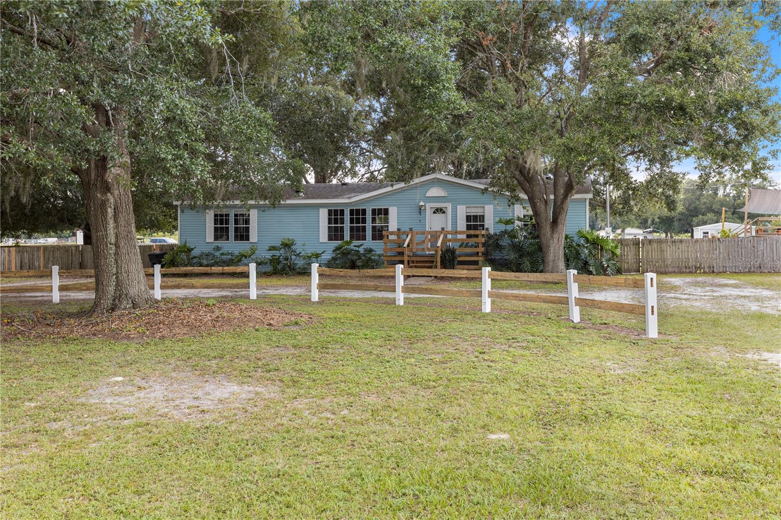 Fully Renovated 3/2 Country Retreat on 2.44 Acres – Zoned AR!
Welcome to this beautifully updated 3-bedroom, 2-bath manufactured home set on 2.44 fully fenced acres, offering the freedom to bring your horses, cows, and four-wheelers while still being close to city conveniences.
Extensive updates provide peace of mind, including a new roof and backyard decking (2019), A/C (2020), kitchen remodel (2020), full replumb (2021), master bath remodel (2024), new front porch (2024), and a newly added covered boat port (12' x 24', 2025). In 2024, the home received a complete subfloor replacement along with all-new exterior insulation under the home, a new vapor barrier, and seamless wall-to-wall laminate flooring throughout.
The property also features a spacious stable/workshop (16' x 25') with plumbing and full electrical, plus a sparkling above-ground pool perfect for cooling off on warm Florida days.
Inside, the home boasts a soft, tasteful décor, an open floor plan filled with natural light, and a welcoming atmosphere that blends modern updates with the charm of country living.
Located just minutes from downtown Zephyrhills, local parks, outdoor adventures, and an easy drive to Tampa and the Gulf Coast beaches, this property is the ideal mix of space, style, and convenience.
Don’t miss your chance to own this versatile, move-in-ready retreat with room to roam!