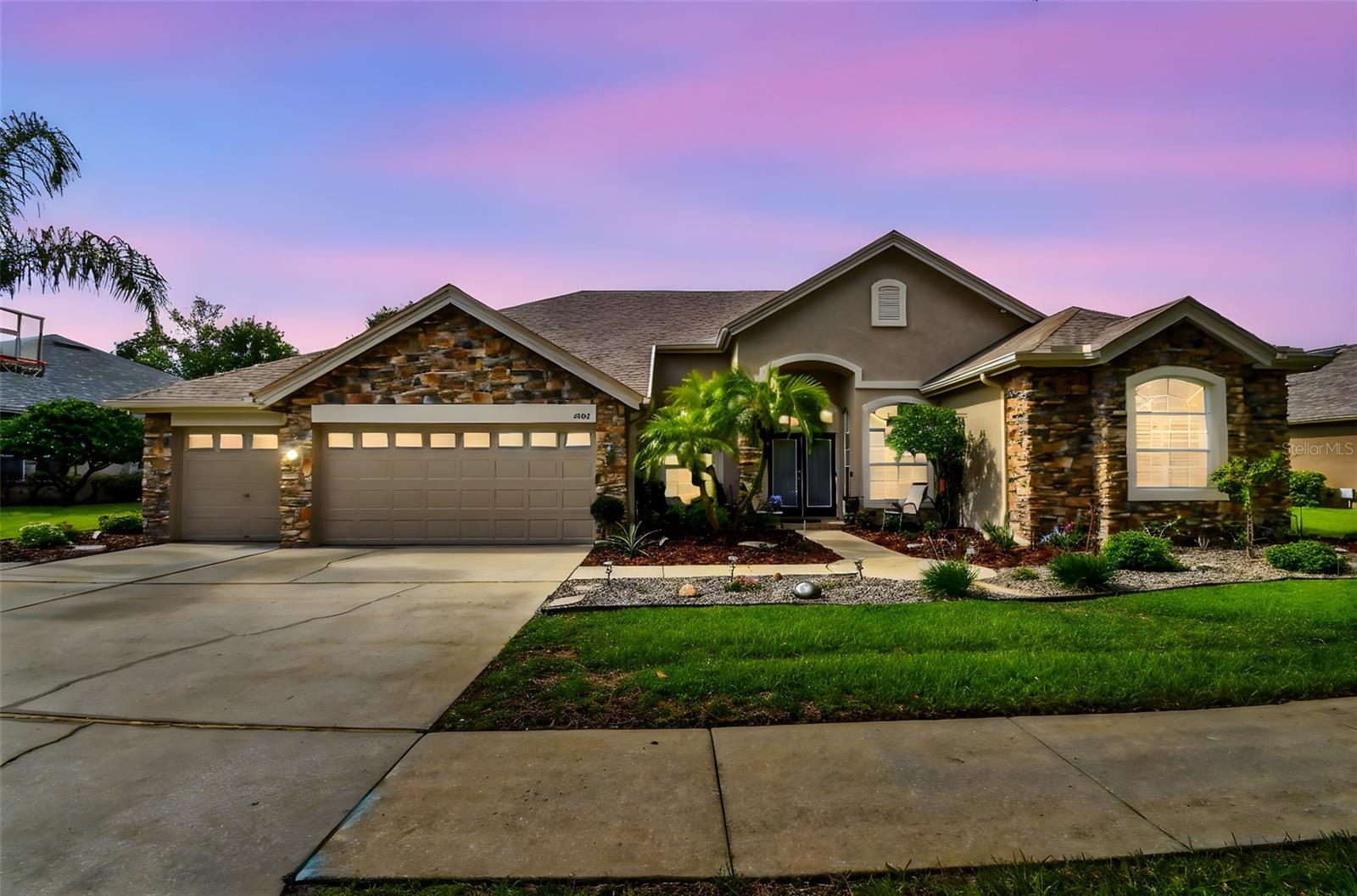 Welcome to 5507 Garden Arbor Drive, a sophisticated retreat nestled in the Villarosa community of Lutz, FL, where luxury and modern convenience converge. This expansive residence spans 3,490 square feet and offers five beautifully appointed bedrooms and four immaculate bathrooms, all situated on a generous .29 acre lot. As you step inside, you'll find an interior highlighted by newer flooring in the main living areas, back in-law suite, and the primary suite, creating a seamless and contemporary living atmosphere. The home provides year-round comfort with central air conditioning and electric heat, complemented by an updated upstairs AC unit installed in 2025. The heart of this home is a gourmet kitchen, designed for modern living and seamlessly connecting to the dining and living areas—ideal for both entertaining and everyday living. Convenience is further enhanced with an attached 3-car garage and a multi-generation friendly floorplan. This property offers a private oasis with a saltwater pool accompanied by a spa/hot tub, perfect for relaxation and leisure. The screened-in lanai provides amazing pond views, creating a tranquil outdoor living space. Situated in a gated community, residents enjoy a wealth of amenities, including a gym, common outdoor spaces, a playground, tennis courts, and scenic waterfront views. The home also benefits from a Culligan Water softener system installed in 2025, ensuring superior water quality. Pet-friendly and meticulously maintained, this home also boasts a new roof installed in 2022, ensuring durability and peace of mind. Experience the perfect blend of elegance and modern comfort at 5507 Garden Arbor Drive—a residence that promises luxurious living in a vibrant community.