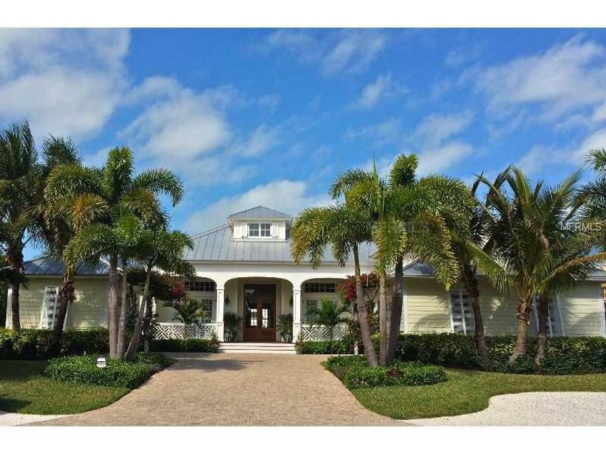 Stunning custom home in Boca Grande Isles located on deep water canal with state of the art dock facilities capable of mooring 100 foot boat, gourmet kitchen, open floor plan, infinity pool, hurricane impact glass on all openings, beautiful landscaping, serene views surround.