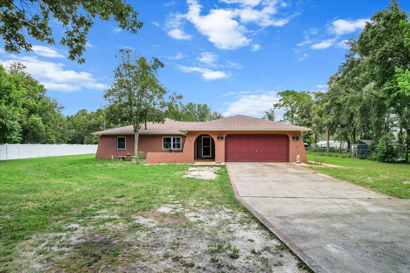 GREEN ACRES IS THE PLACE TO BE! Live the country life on Green Acres St in this spacious pool home your family will enjoy. The archway to the front porch adds charm and curb appeal to this fully fenced and gated almost 1 acre property. Step inside to the great room with gas fireplace that is open to the updated kitchen with wood cabinetry and granite counters. The formal dining space will accommodate family dinners. There is a private office for when you need to concentrate on the work at hand. The master suite has sliders to the kidney shaped pool and a private bath and walk-in closet. Bedroom 2 and 3 are split by the hall bath. Spend lazy days relaxing, reading a book or going for a swim in the sparkling pool. The expansive Florida Room (19X18) has many possibilities for whatever suits your lifestyle - hobby room, game room and more ! ROOF 2022, HVAC 2023. Located less than 1 mile from US HWY 19 for quick access to shopping, dining, local waterways and more ! Come take a look and see all this home has to offer.