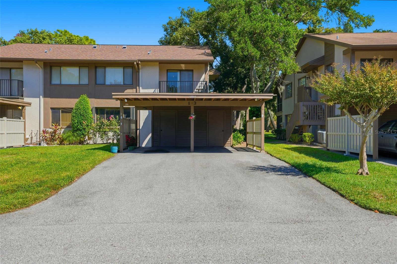 One or more photo(s) has been virtually staged. Welcome To 12906 Wedgewood Way Unit B, A Beautifully Maintained Ground Floor Condo on the Golf Course. This 2 Bedroom, 2 Bathroom Condo Offers an Open Main Living Area with A Split Bedroom Floor Plan for Added Privacy. The Home Features Laminate Flooring Throughout The Main Living Areas and Bedrooms, While the Kitchen, Baths, and Lanai are Finished with Durable Tile. Enjoy the Open Front Patio Perfect For Relaxing or Greeting Guests, Along With A Rear Tiled Lanai Overlooking Peaceful Golf Course Views. Recent Updates Include a New Roof and a Newer HVAC System, Built-in Hurricane Shutters on ALL Windows, Providing Comfort And Efficiency Year-Round. The Condo Association Covers Roof, Exterior Maintenance, Pool, Clubhouse, Shuffleboard, Cable, Internet, Water, Sewer, Trash, and Carport, Offering a Lower-Maintenance Lifestyle In A Well-Cared-For Community.