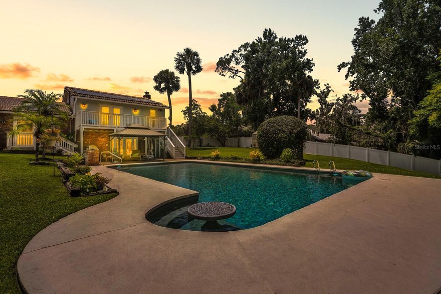 Discover an extraordinary sanctuary where elevated waterfront living meets timeless Florida charm. Perched above the Little Tomoka on .78 acres, this retreat offers direct access to the Tomoka and Intracoastal with preserve views ensuring privacy and manatees visiting often. A multigenerational layout features two bedrooms downstairs and three upstairs, with a lower level bar and fireplace opening to an eleven foot deep pool and new decking. The kitchen’s chef’s 6-burner gas range is ideal for culinary enthusiasts. Whole home solar panels reduce energy costs and the tile roof, only a few years old, adds long term peace of mind. Fresh balcony and dock decking plus a new paver driveway enhance outdoor living. Unlike neighboring properties, this elevated home offers rare flood protection while minutes to I-95, beaches, shopping, and hospitals.