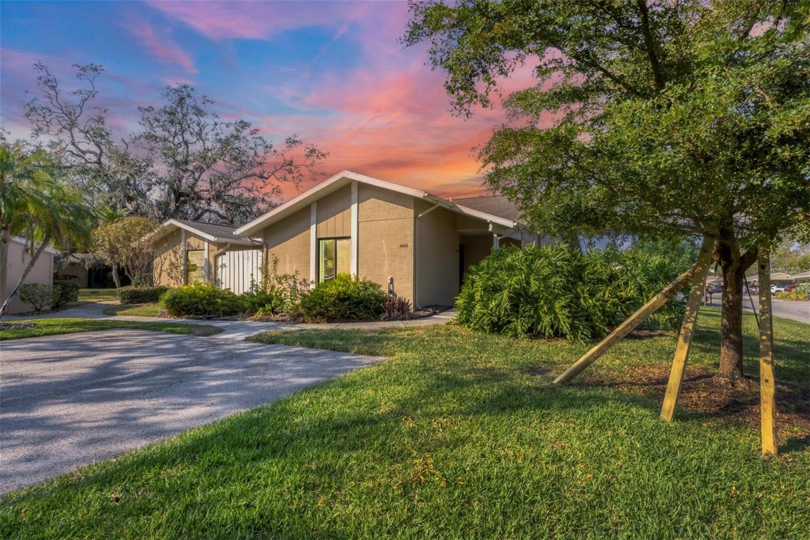 WAIT till you see this BEAUTIFULLY UPDATED villa in 55+ TALLYWOOD centrally located close to downtown Sarasota, St. Armand's/Lido, UTC, I-75 and SRQ! This home has plenty of large windows to the East, North and South to let the Florida sunshine in. The Cathedral ceilings lend volume and size to the common area rooms. You have 2 bedrooms (Split plan) PLUS a den with a BARN DOOR and can easily be converted back to a 3rd bedroom, BOTH full bathrooms have been updated including commodes, vanities, vessel bowl sinks shower doors and European digital temp controlled shower. Updated kitchen includes new wood, soft close cabinetry, granite countertops, tile backsplash and a suite of stainless steel appliances, as an added bonus there is a small fenced in patio off the kitchen for BBQ or a bistro table/chairs. Newer flooring with 5.25" floor molding and all interior windows have been replaced with HURRICANE IMPACT GLASS windows. As an added bonus you will appreciate the beautifully updated Florida room that has newer removable windows (non impact) to get a 4 seasons room. You have an assigned carport with a storage room as well very close to your front door. Your new villa is an end unit affording more windows and natural light and sits on a quiet corner lot. Other features include the removal of popcorn ceilings, extra attic insulation, matching suite washer dryer, newer hot water tank upgraded electrical to include recessed lighting and modern switches, 6 ceiling fans, new gutters in the back, interior doors and hardware, Ring security video and doorbell, Schlage key pad dead bolt plus NEST thermostat. Community amenities include oversize caged pool, clubhouse for community events, fitness area and shuffleboard. Price improvement: $298,000