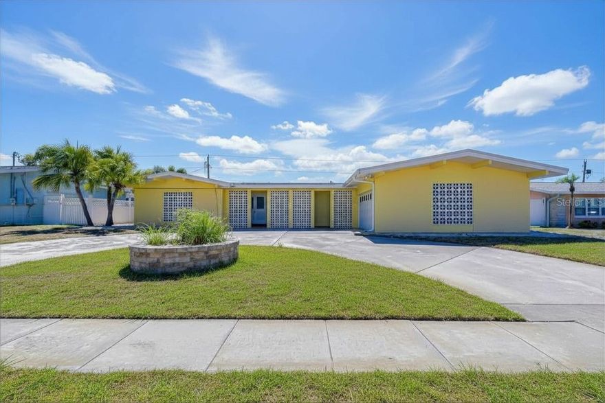 Welcome to this beautiful residence in the highly desirable Yacht Club Estates in Seminole, where modern comfort, thoughtful upgrades, and exceptional outdoor living come together. This three-bedroom, three-bath home offers 2,068 square feet of well-designed living space with multiple areas to relax, entertain, and enjoy the Florida lifestyle. A circular driveway provides easy, convenient access to the home, leading to an oversized 660 SF garage equipped with an electric Tesla charger. Inside, the home features two spacious living areas that offer flexibility for both everyday living and entertaining. The chef’s kitchen is a true highlight, featuring crisp white shaker cabinetry with abundant storage, quartz countertops, a farmhouse sink, newer appliances, and a large pantry. A recently added dry bar with wine fridge enhances the home’s entertaining capabilities. All bathrooms have been fully updated for a clean, cohesive look throughout.  The spacious primary suite includes two closets and direct access to the pool area, creating a private retreat feel. The home also offers generous storage throughout and convenient indoor laundry. Step outside to a true backyard oasis—an expansive screened-in pool area with a large covered patio and built-in outdoor grill, all overlooking peaceful pond views. The solar-heated pool is equipped with solar panels, extending enjoyment year-round. The backyard has been thoughtfully enhanced with pavers, artificial turf, and flexible space ideal for a fire pit, dog run, or additional lounging areas. A versatile bonus outdoor room offers endless possibilities as a home office, guest space, or tiki bar.  Major improvements include HVAC (2016) with added UV light system, roof replacement (2020), and a new water heater (2025). Enjoy direct access from your backyard to the Baypointe Conservation area, seamlessly connected to the neighborhood and offering nearly 3 miles of scenic nature trails. This home presents an exceptional opportunity to live in a prime Seminole location with everything the area has to offer just minutes away. The neighborhood features no HOA while maintaining a strong sense of pride in ownership, all set on desirable high elevation.  Ideally situated two international airports, fresh local seafood and dining, shopping, and the sugar-sand beaches of the Gulf of Mexico, this location offers unmatched convenience. The home is also zoned for top-rated schools and is less than five minutes from Walsingham Park, featuring 354 acres of natural beauty, a 100-acre lake, fishing areas, a six-mile trail system, new playground, and fitness stations. This is a rare opportunity to own a fully upgraded, move-in ready home in one of Seminole’s most sought-after neighborhoods. Schedule your private showing today.