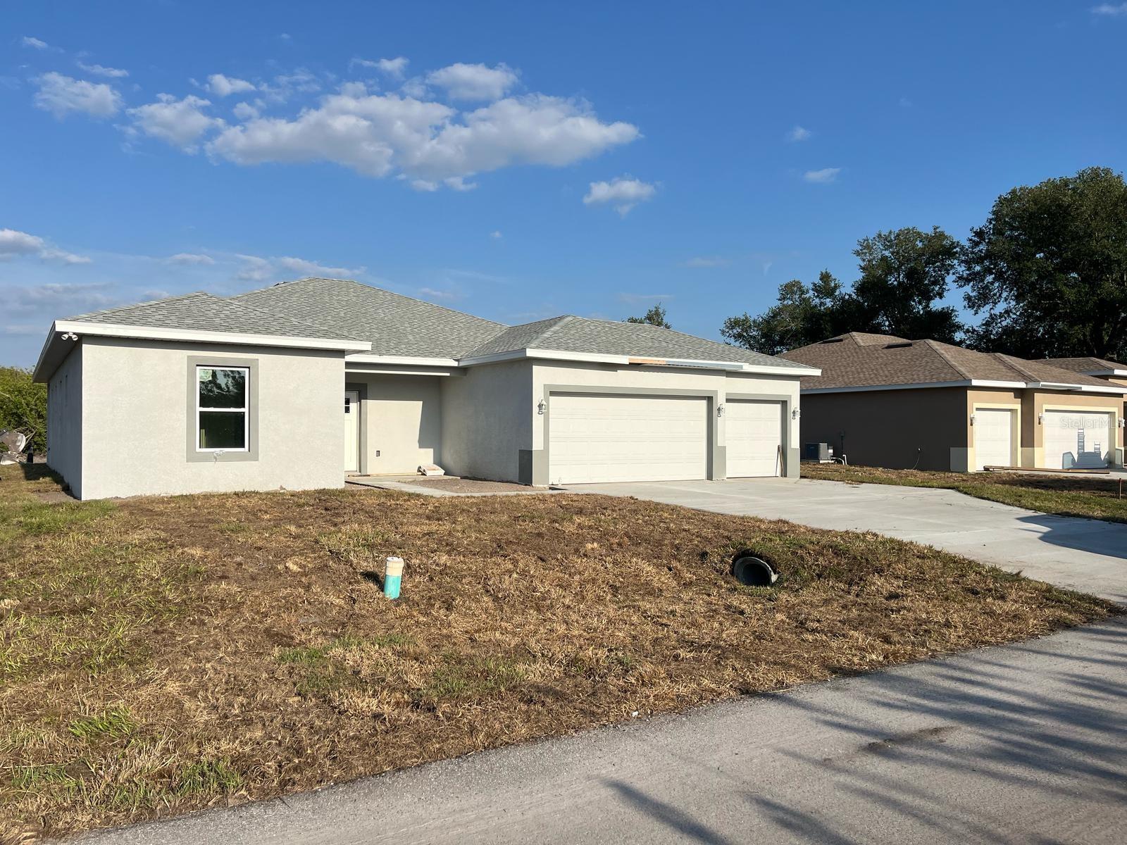 QUICK MOVE-IN!! Welcome to your dream home in North Port! This modern new construction home offers 4 spacious bedrooms and 3 luxurious baths. As you step inside, you'll be greeted by a stunning open floor plan. The exquisite earth toned porcelain tile flooring flows throughout the entire house and is complemented by recessed lighting that enhances the contemporary style. The gourmet kitchen is a chef’s delight, featuring elegant quartz countertops, and solid wood soft-close shaker cabinets. A large pantry ensures ample storage, while stainless steel appliances add a touch of sophistication. Retreat to the primary bedroom, which along with the guest bedroom, includes a spa-like en-suite bath. Experience relaxation in the stunning open walk-in shower, complete with gorgeous porcelain tile. The home's thoughtful design includes en-suite baths for 3 of the 4 bedrooms, ensuring comfort and privacy for guests. This home does come complete with hurricane impact windows. Water and Sewer gravity provided by City of North Port. Run before it gone!! Equal Opportunity Housing.