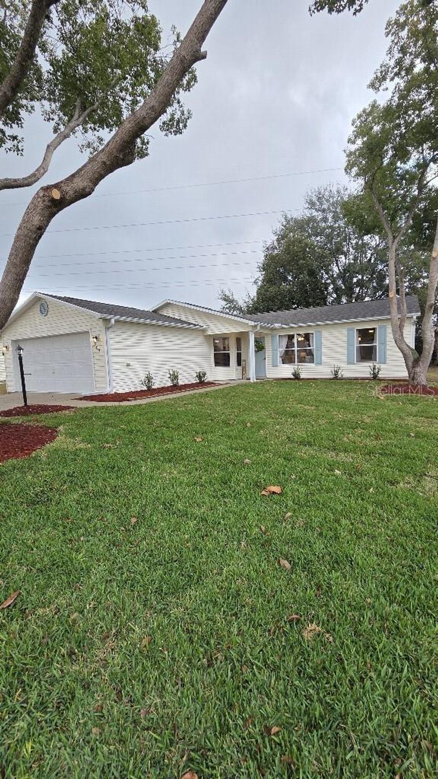 Renovated this fall, this stunning 2 bed, 2 bath home with a 2 car garage comes turnkey with warm, soothing tones. You'll love this beautifully furnished home where quality meets timeless style, drenched in natural light. It features a new roof, A/C, water heater, kitchen cabinets, quartz counters, LVP flooring, light/fans, window treatments, vanities, commodes and much more. It backs to open space, creating a quiet setting with enhanced privacy. This home is in a prime location, between Lake Sumter and Spanish Springs. The bond is paid and there's definitely no "honey-do" list, just come enjoy this lovely home from day one!