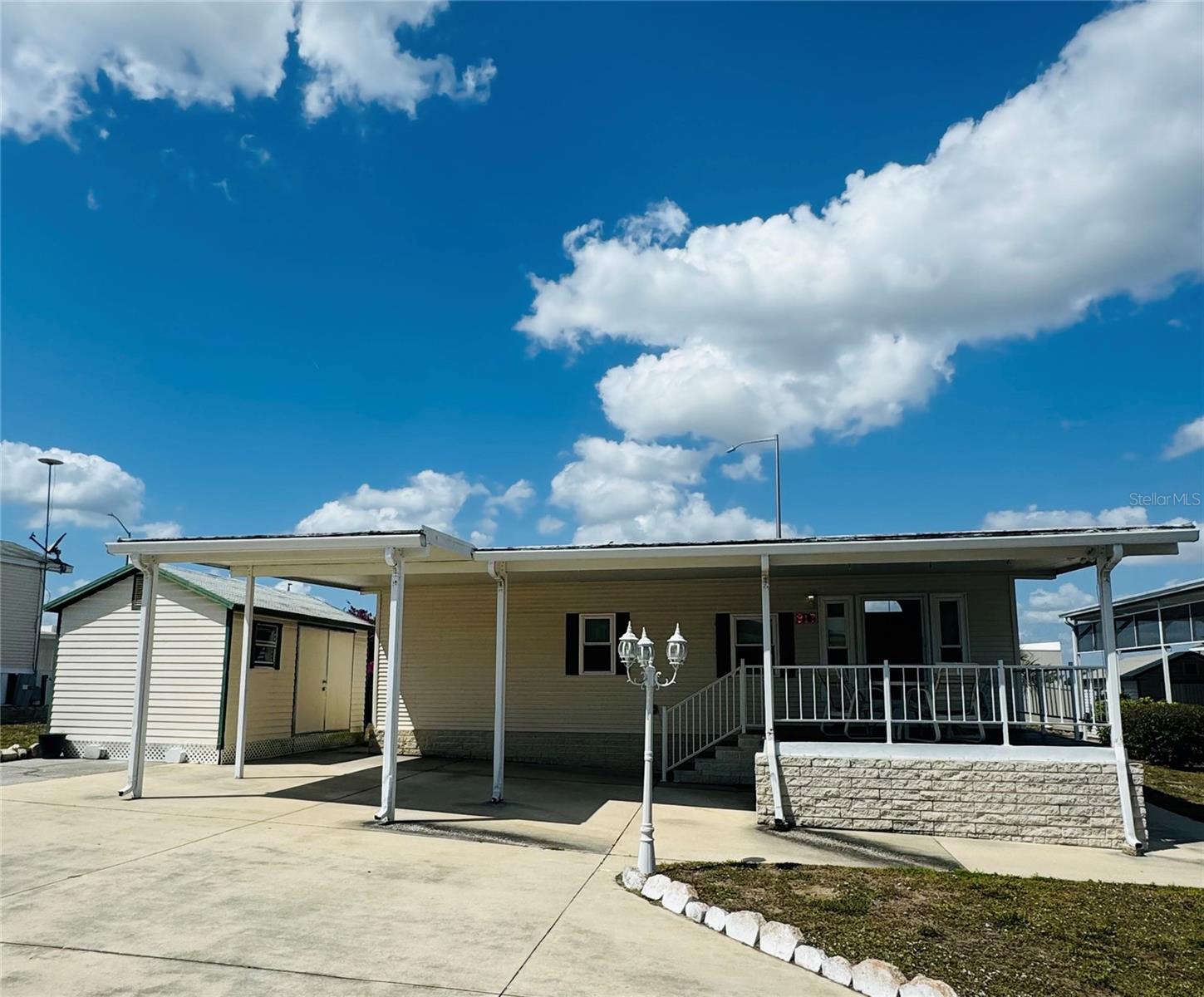 Welcome to DEER CREEK RV GOLF & COUNTRY CLUB! It’s the perfect time to purchase your new FLORIDA GETAWAY! Whether you are looking for a sunny place to winter or a full-time residency, this two-bedroom, two-bath, well-maintained park model is perfect! Situated on two lots in Osprey Point, this home boasts an open floor plan with living, kitchen & dining room! Sliding doors off the kitchen lead to the Florida Room overlooking the back yard! Beautiful green space with lots of flowering bushes & trees! The large, covered patio/carport is a great place for entertaining with family & friends! There’s plenty of parking for your cars & golf carts plus a shed for storing your golf clubs & toys. You’ll love sipping your coffee or reading your favorite book on the 12 x 12 front deck! The Osprey Point Community Clubhouse, Pool, Hot Tub, Shuffleboard Courts & many activities are just a golf cart ride away! If you love RESORT style living, this is the place for you & perfect for guests! Deer Creek Community also has a MAIN CLUBHOUSE offering a variety of social events throughout the year such as Karaoke, Trivia, Cardio Drumming, Line Dancing, Crafts, Swing Dancing & more! Soak up the sun at Deer Creek’s MAIN pool, cabana & hot tub area! Try water volleyball, pickleball, tennis, shuffleboard or pool aerobics! Love golfing? Check out Deer Creek’s 18 Hole Executive Golf Course Leagues & shopping at the Pro Shop! The Tiki Bar is a great place to meet new friends with occasional live bands & music! The Greenside Grill is perfect for onsite dining! Deer Creek is centrally located in Davenport just 20 minutes from Disney & all the attractions that families enjoy! Hop on your golf cart & ride to many restaurants & shops nearby. Bealls, Marshalls, Target & Star Bucks are in Posner Park less than a mile away! Call today to view this HIDDEN GEM in sunny Florida! Just 1.5 hours to each coast! Come & tour Deer Creek today!
