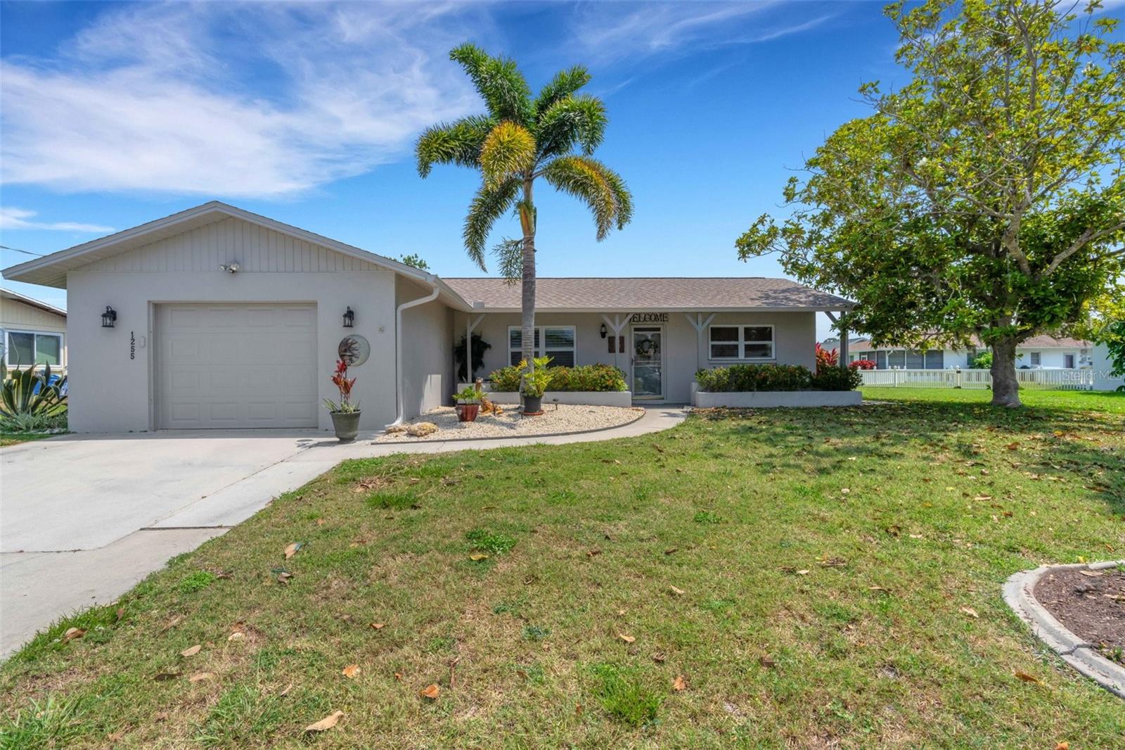 Charming Waterfront Retreat in Englewood! Welcome to your fully furnished waterfront oasis, complete with a new roof (2022) and new water heater (2021) for peace of mind. From the moment you step inside, you will be greeted by sweeping water views that set the tone for relaxed Florida living. The split-bedroom layout offers privacy for everyone, with a primary suite featuring its own ensuite bathroom and walk-in closet. The true heart of the home is the bright Florida room, showcasing walls of windows with remote-controlled shades and an impact-rated slider that frame the tranquil scenery. Step outside and enjoy two spacious outdoor seating areas, plus a 10x5 dock/deck that invites you to fish, kayak, or simply soak up the views right from your backyard. Practical features include a 10x13 storage shed and an oversized garage outfitted with a washer/dryer, utility sink, extra refrigerator, cabinets, and a workbench, perfect for storage and hobbies. All of this is just minutes from top dining, shopping, entertainment, and the world-renowned Gulf beaches, making it the perfect blend of comfort, convenience, and coastal lifestyle.