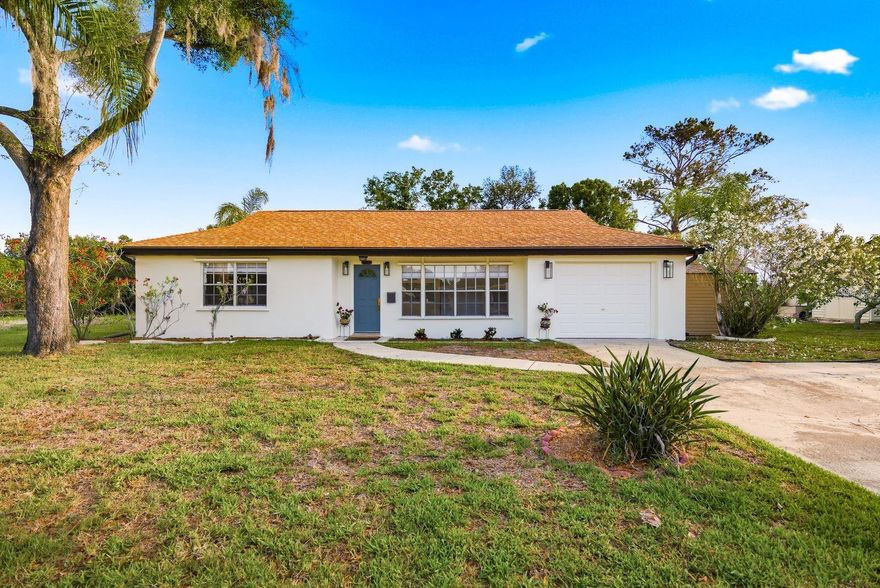 One or more photo(s) has been virtually staged. Welcome to YOUR TROPICAL PARADISE! This LIGHT & BRIGHT STUNNING POOL HOME captures the ESSENCE OF FLORIDA LIVING!  Nestled on an OVERSIZED LOT with breathtaking views of Sawyers Basin and the Pasco Palms Preserve (a protected bird sanctuary), this property offers rare, unobstructed nature views with no rear neighbors. The light-filled interior showcases a New Kitchen with crisp white cabinetry, a striking blue ceramic backsplash, and new stainless steel appliances. New Luxury vinyl plank flooring runs throughout the bedrooms, and the fully remodeled bathroom brings a clean, modern finish. Freshly painted inside and out, the home feels inviting and move-in ready from the moment you arrive. Custom Roman Shades have just been installed throughout, adding a polished look to every room. A brand-new 2024 HVAC system means you can enjoy cool, efficient comfort for years to come. Other recent updates include a 2020 Roof, a 2021 Electric Water Heater, and a 2025 Pool Pump.  Step outside to your private backyard oasis featuring a sparkling pool, a tiki-inspired lanai, and a fully fenced yard — with extra space to park a golf cart or boat. The attached garage adds everyday convenience. Whether you're casting a line, launching a kayak, or paddleboarding across the basin, effortless water access is simply part of the lifestyle here. Hurricane shutters provide peace of mind season after season. No HOA — though optional membership in the Beacon Square Civic Association is available for a yearly fee, offering access to a pool, grills, a playground, a game room, a library, and a gym. Conveniently located just off US 19, minutes from shopping, dining, beaches, and parks — and only 4 miles from vibrant downtown New Port Richey.  Do not miss out on this one! Schedule your private showing today!