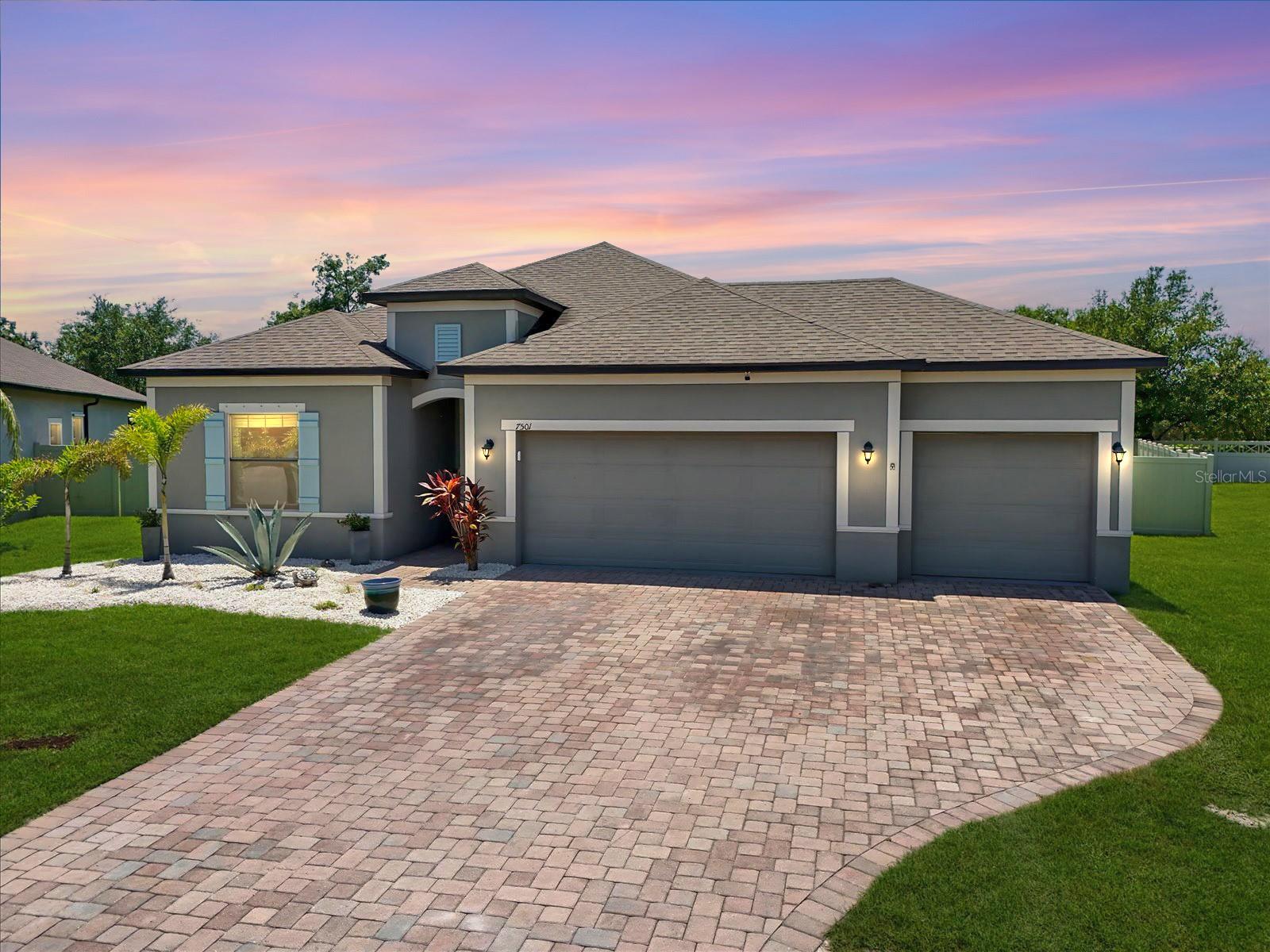 Step into comfort, style, and effortless Florida living at 7501 37th Avenue East in Palmetto! Built in 2017, this beautifully maintained home offers an open-concept layout, ideal for both everyday living and entertaining. A custom etched glass front door welcomes guests into a bright foyer that flows into spacious living and dining areas, all accented by sleek tile flooring and filled with natural light.
At the heart of the home is a stunning upgraded kitchen featuring rich wood cabinetry, a stylish backsplash, stainless steel appliances, double ovens, a walk-in pantry, and an oversized island perfect for meal prep and casual conversation alike.
The private primary suite is a spacious retreat, complete with a tray ceiling, large walk-in closet, and a well-appointed en-suite bath with dual sinks, a soaking tub, and a walk-in shower. Thanks to the split-bedroom layout, everyone enjoys their own space and privacy.
Step outside and the Florida lifestyle really comes to life. Entertain on the screened lanai with a built-in grill and wine fridge, or relax on the extended paver patio in your fully fenced backyard. Whether you’re hosting friends or enjoying a quiet evening outdoors, this space was designed to impress.
A three-car garage and pavered driveway add convenience for more room for storage and parking.
Conveniently located near shopping, dining, schools, and easy highway access—this home puts you close to everything while offering your own slice of paradise. Don’t miss your chance to make it yours—schedule your showing today!