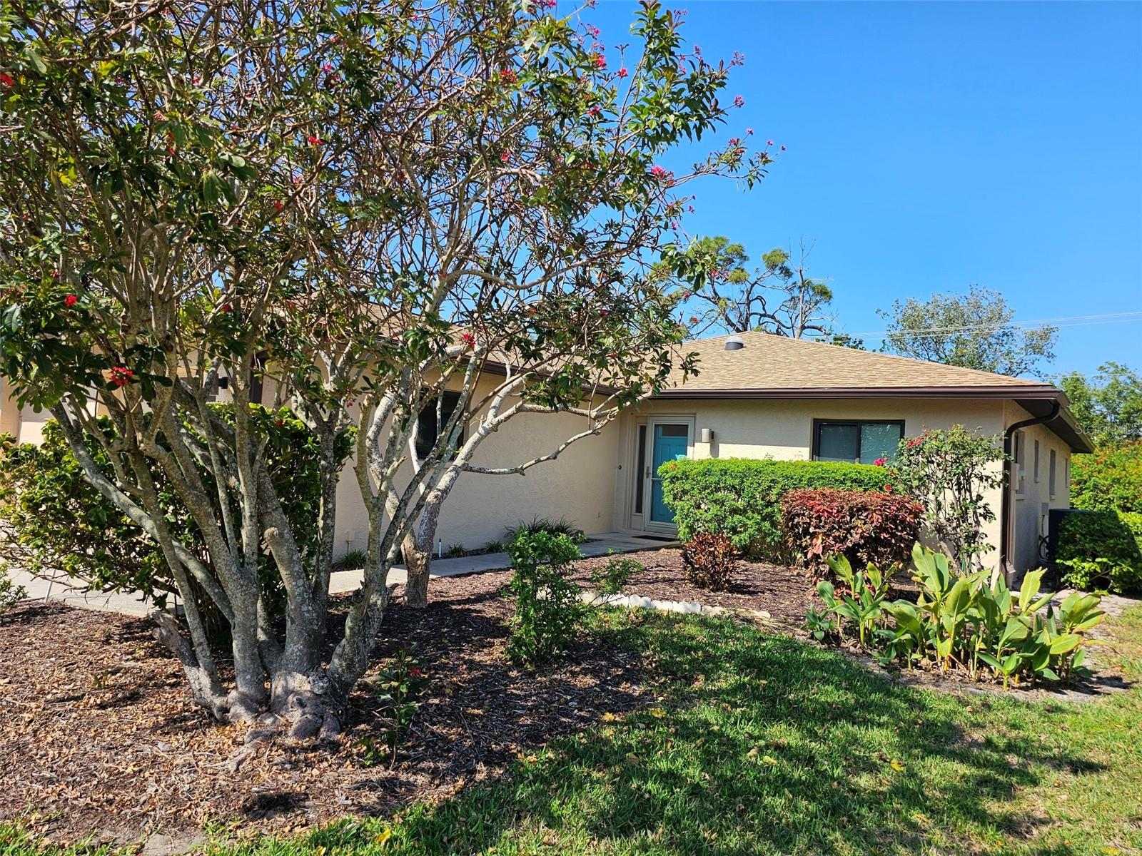 Welcome to this beautifully updated single villa offering the perfect blend of comfort, style, and convenience. This spacious 3-bedroom, 2-bath home features wood and tile flooring throughout, and a bright, open layout designed for easy living. The heart of the home is the large, well-appointed kitchen with granite countertops, abundant cabinetry, a range with range hood, refrigerator, and dishwasher. A breakfast bar opens to the dining area—ideal for casual meals or entertaining. Adjacent to the kitchen is an interior laundry room with direct access to the attached 2-car garage. The inviting living and dining areas flow into the Florida room—a charming space with cozy seating and a table, perfect for morning coffee or afternoon tea. From here, step outside to the open patio, complete with a grill and room to relax or dine under the sky. The main bedroom features a king-size bed, walk-in closet, and an en-suite bath with granite counters, a walk-in shower, and custom built-in cabinetry. The guest bedrooms are equally comfortable—one with a king bed, the other with a queen—sharing a stylish guest bath with a tub/shower combination. Located in a vibrant community with access to a clubhouse, heated pool, hot tub, tennis and sports courts, this villa offers an active Florida lifestyle. Conveniently situated near IMG Sports Academy, State College of Florida, Detwiler’s Farm Market, shopping, dining, and just 5 miles to the beautiful Gulf beaches.