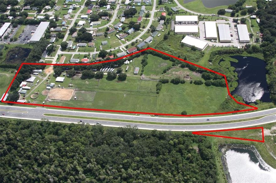 14.26 Acres of High and Dry Industrial Development land fronting the new Hoagland Rd extension in Kissimmee. Currently utilized as an equine boarding and training facility. Located on the back of Kissimmee Gateway Airport in the rapidly growing corridor. Minutes to all the main highway arteries connecting Central Florida. Ideal shape and size for a new tilt wall project with plenty of depth and over 1200 SF of frontage. 2 curb cuts provided with the road expansion require no u-turn and direct access. Water, Electric, and Data are at the site. The sewer is one parcel over. Zoned IG (Industrial General). Allowable Use table and wetland pdf attached. Flyer and OM in production.