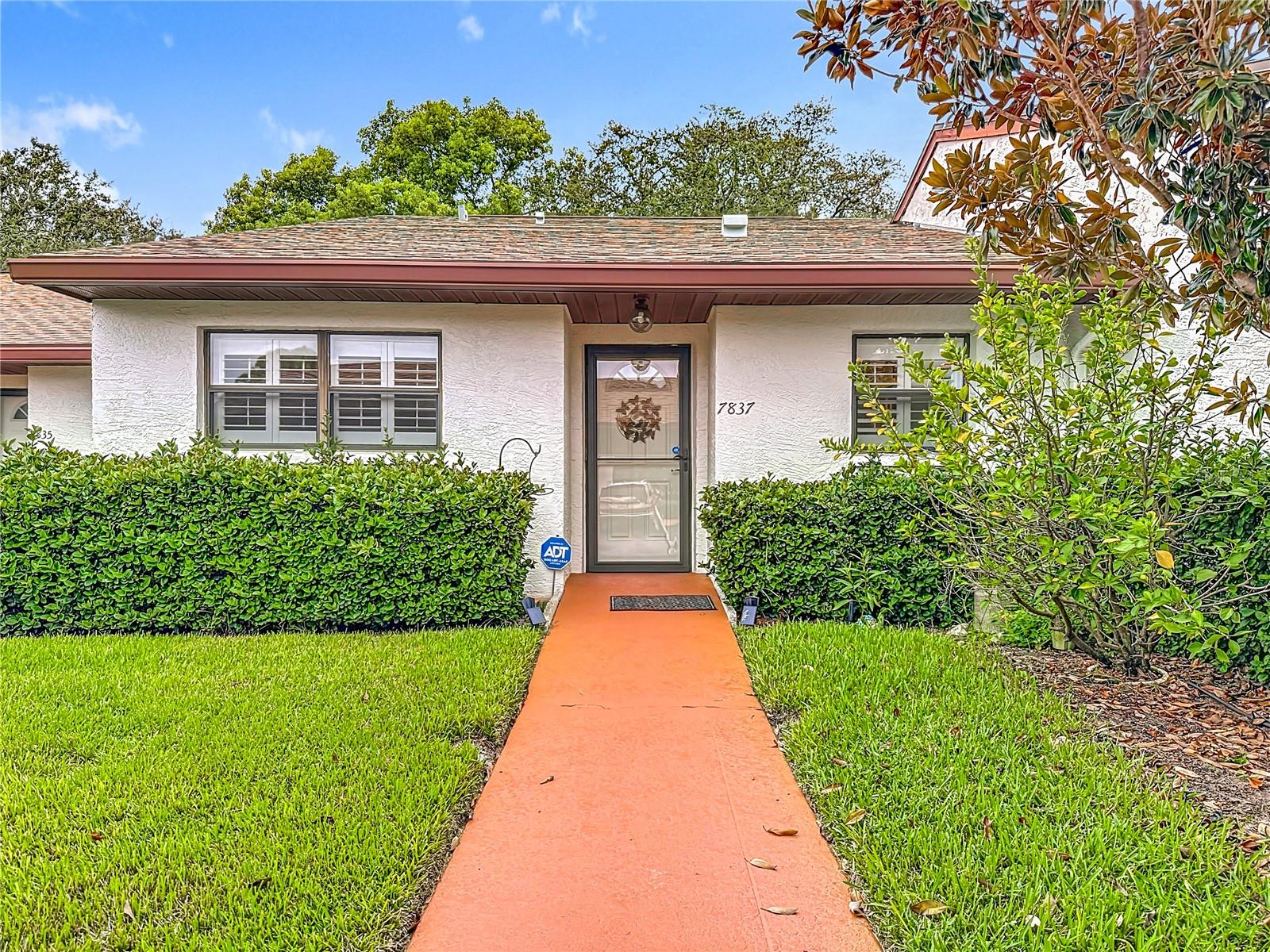 Welcome to this charming 2-bedroom, 2-bathroom condo located in the desirable gated community of Orchards of Radcliffe in Port Richey, FL. Nestled on a lovely lot with a beautifully landscaped view in the back, this home offers a peaceful and inviting setting. Inside, you’ll find thoughtful updates throughout. The kitchen has been refreshed with a new sink and faucet and modern updates that make meal prep a pleasure. The home features luxury vinyl flooring flowing seamlessly through the kitchen, dining, and family room, while can lighting brightens the main living areas with a modern touch. Additional updates include all new interior doors, adding both style and function. This home is equipped with its own alarm system for added peace of mind. Step outside to the shaded lanai, perfect for relaxing with your morning coffee or unwinding at the end of the day while enjoying the serene, landscaped backdrop. The Orchards of Radcliffe is a welcoming community offering a sparkling pool and clubhouse activities and providing plenty of opportunities to connect with neighbors and enjoy an active lifestyle. The association fee provides incredible value covering: cable, internet, exterior maintenance, pest control, pool, sewer, trash, water, and more leaving you free to enjoy a truly low-maintenance lifestyle. Don’t miss your chance to own this well-maintained condo in a fantastic location. Schedule your showing today!