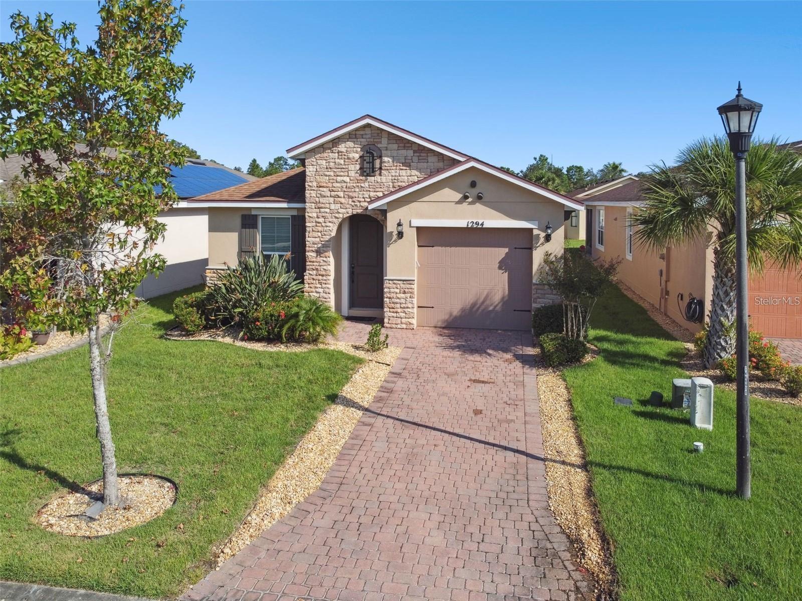 This beautifully upgraded 3-bedroom, 2-bathroom residence offers comfort, style, and efficiency. FURNISHED AND READY FOR A QUICK MOVE-IN! The open floor plan features spacious living and dining areas, perfect for entertaining or relaxing. The chef-inspired kitchen showcases granite countertops, a striking tile backsplash, eat-at island, stainless steel appliances, and a mix of recessed and pendant lighting for a modern touch. The expansive primary suite includes a spa-like en-suite bathroom with dual sinks, a walk-in shower, and generous walk-in closet. Ceramic tile flooring runs throughout the main living spaces, while plush carpet creates warmth in the bedrooms. Double atrium doors lead to the versatile third bedroom or den. Enjoy Florida living on the screened-in lanai, with peace of mind from energy-efficient double-pane windows and ceiling fans throughout. A solar panel system keeps utility costs low, while the ion exchange water conditioner adds extra convenience. Additional highlights include all furnishings included, a freshly painted exterior (2022), and a golf cart available for purchase. All this in one of the top 55+ communities in America. Solivita offers residents access to state of the art amenities and work out facilities, dance and aerobics studios, a business center, 14 heated swimming pools, 2 heated spas, tennis courts, pickleball courts, shuffleboard, bocce ball, billiards room, art gallery, 3 restaurants and 2 championship 18-hole golf courses, driving range and putting course. Every day offers something new to explore and enjoy! This home also features easy access to nearby shops, dining, and health care, offering the perfect balance of privacy and lifestyle. Don't miss out on the opportunity to have a first class lifestyle.