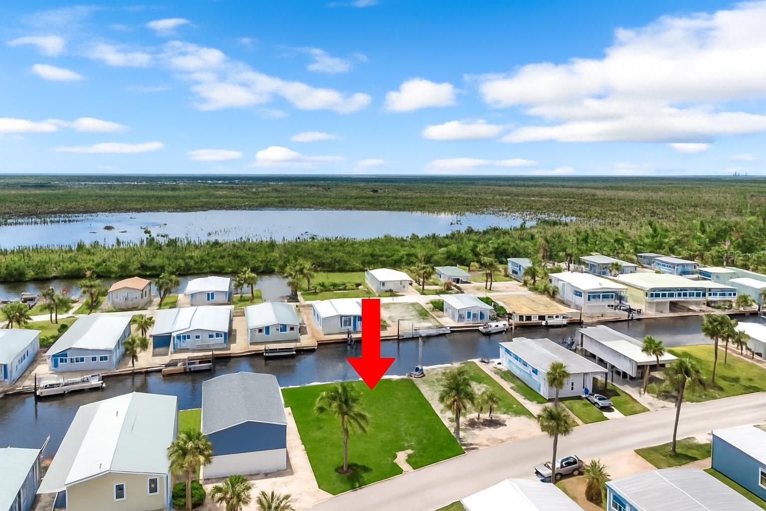 Welcome to this rare opportunity in the highly desirable 55+ community of Bayside Estates - a vibrant, active neighborhood just 2.5 miles from Fort Myers Beach and the famous Jimmy Buffett’s Margaritaville Resort! Cruise to the beach, shops, or up and coming restaurants or relax and enjoy the canal-front lifestyle with direct Gulf access right from your backyard. This eastern rear exposure lot offers beautiful morning sunrises and the perfect setting to build the home of your dreams. With your very own private dock,10,000 lb. boat lift and fishing station, you can enjoy boating, kayaking, or fishing from your own slice of paradise. Residents love the amenity rich lifestyle here - pickleball, tennis, bocce, a community pool, and social events that keep the fun going year-round. Don’t miss your chance to be part of this welcoming and energetic coastal community!