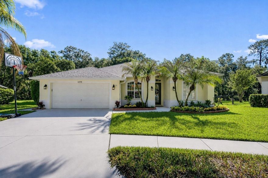 Perfectly positioned at the end of a quiet cul-de-sac, this beautifully maintained residence offers an exceptional combination of privacy, space, and serene conservation views—set on an oversized homesite in one of FishHawk’s most desirable locations. From the moment you arrive, the setting impresses. The expansive, iron-fenced backyard backs to lush conservation, creating a peaceful natural backdrop while still offering plenty of room for play, pets, and outdoor living. The cul-de-sac location enhances both privacy and safety, providing a low-traffic environment ideal for everyday living. Inside, the home immediately reflects pride of ownership, with updated flooring and thoughtfully refreshed interiors that create a clean, move-in ready feel throughout. A formal living room and separate dining room welcome you with elegant architectural details, including tray ceilings and graceful archways that add character and dimension. At the heart of the home, the spacious family room features custom built-ins and seamlessly connects to the kitchen and outdoor living areas. Sliding glass doors open to the lanai, creating a seamless indoor-outdoor flow. The kitchen is both functional and inviting, featuring rich cabinetry with crown molding, stainless steel appliances, a breakfast bar, and a bright breakfast nook overlooking the pool and backyard. The intelligently designed three-way split floor plan offers privacy and flexibility for a variety of lifestyles. Two secondary bedrooms are positioned along a private hallway and share a full bath, along with a built-in workspace ideal for a home office or study area. A separate fourth bedroom and full bath are tucked away at the rear of the home—perfect for guests or multigenerational living. The primary suite is a true retreat, privately situated at the front of the home and featuring a tray ceiling, direct access to the lanai, and dual walk-in closets. The updated en-suite bathroom offers a fresh, modern feel with a soaking garden tub, separate walk-in shower, and dual vanities—creating a relaxing, spa-like escape. Additional bathrooms have also been tastefully updated, adding to the home’s overall appeal. Step outside to your own private oasis. The screened-in pool and lanai create the perfect setting for year-round enjoyment, whether relaxing or entertaining. Combined with the expansive backyard and tranquil conservation views, this outdoor space is truly a standout feature of the home. This home has been meticulously cared for and thoughtfully updated, offering peace of mind for its next owner. Located in the highly sought-after FishHawk community, residents enjoy access to top-rated schools and an unmatched array of amenities, including resort-style pools, fitness centers, miles of walking and biking trails, parks, playgrounds, tennis and basketball courts, and a vibrant calendar of community events. This is more than just a home—it’s a lifestyle opportunity in one of the area’s premier communities.