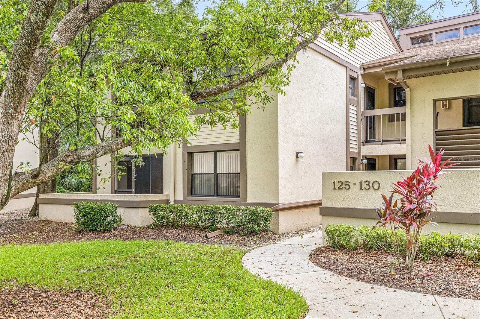 Updated first floor end unit condo in the Woodlake Run area of East Lake Woodlands gated golfing community. Private and beautiful, this end unit condo has foyer entrance into the living/dining area complete with newer vinyl plank flooring thru out and a side window for plenty of extra lighting, sliders out to the glass enclosed lanai overlooking the private setting of tropical bushes and trees. There is a breakfast bar into the kitchen with granite counters, plenty of cabinet space including a cabinet wall pantry and another set of sliding doors out to a front screen enclosed lanai where the utility closet is located. The condo is designed with a split bedroom plan and has carpet in both bedrooms. The primary suite with its own private door entrance has a primary bath with newer walk in shower and spacious double sink vanity, two closets plus sliding doors out to enclosed lanai in the back. The second bedroom offers a wall closet, more sliding doors out to the front screen enclosed lanai. Guest bath with walk in shower, linen closet and updated vanity. Community heated pool nearby for your enjoyment and water, sewer, trash, basic cable and internet is included in the rent. This is a non smoking/vaping residence and the owner would prefer no pets please.
