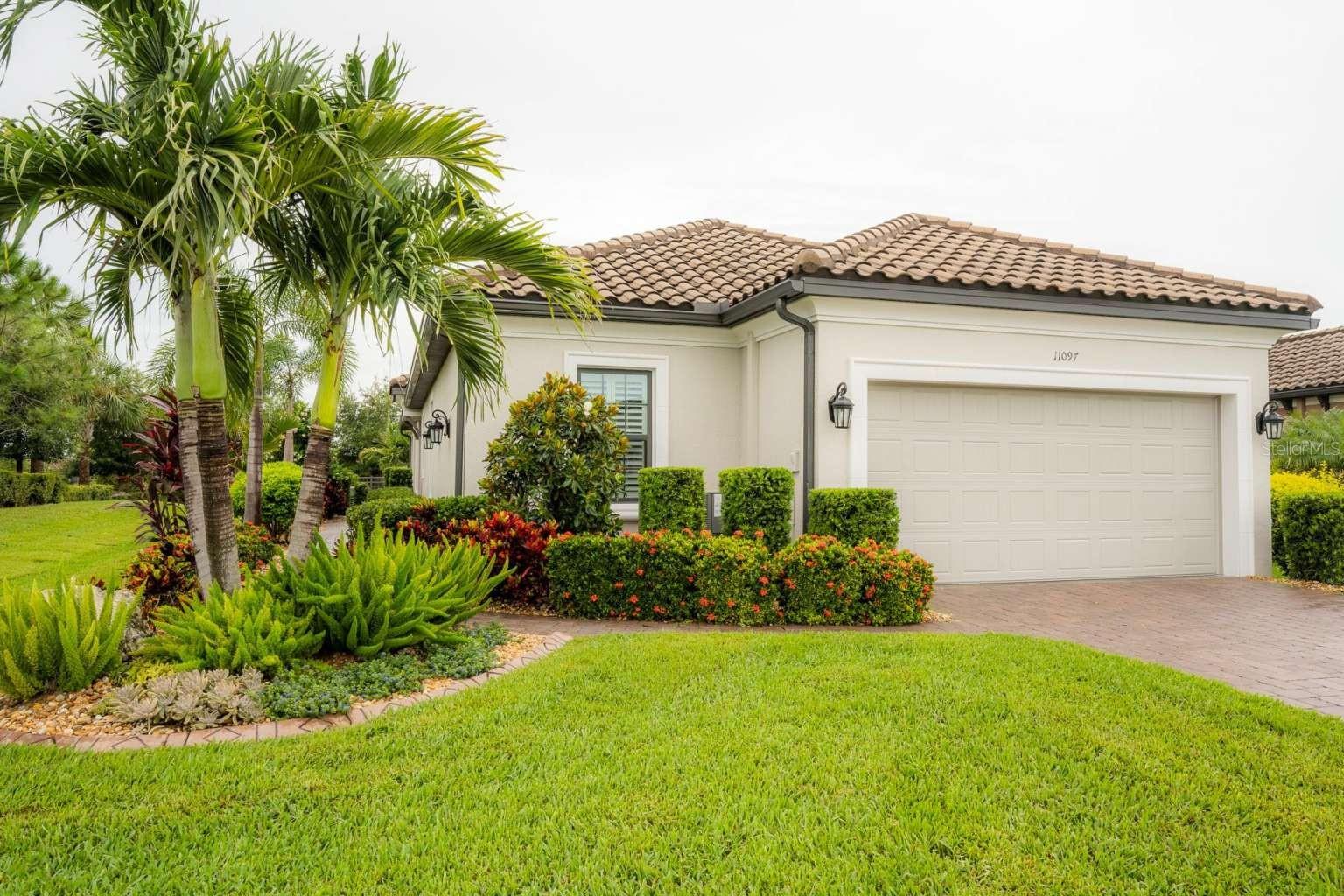 WHY WAIT TO BUILD? ENJOY THE FLORIDA LIFESTYLE IN THIS BETTER THAN NEW TAYLOR MORRISON AREZZO MODEL IN THE GATED COMMUNITY OF ESPLANADE AT STARKEY RANCH! This 1,931 SF Mediterranean style ranch is located on a corner lot with views of conservation land & features a large, fully fenced yard with no rear neighbors. With over 90K in high quality aftermarket upgrades, this home is an unbeatable value. Exterior highlights include a tile roof, whole house professionally painted with SW Loxon Conditioner & 2 coats of SW Emerald paint, lush landscaping with concrete curbing, irrigation, screened lanai with solar shades & a KOHLER 20 kW WHOLE HOUSE GENERATOR! Interior features include a stone feature wall, COREtec LVP and 18”x18” tile flooring, plantation shutters, motorized shades, upgraded lighting & fans, oil rubbed bronze hardware & fixtures. The spacious family room is perfect for entertaining with a tray ceiling, recessed lighting, crown molding & expansive views of the backyard & conservation area. The generously sized dining room is highlighted by a transom window, tray ceiling & wainscoting trim. A chef’s dream, the kitchen boasts a CAFE 6 BURNER DUAL FUEL DOUBLE OVEN with Hauslane 850 CFM vent hood, pantry microwave, Samsung smart refrigerator & dishwasher, Windsor Maple Truffle cabinetry with 42” uppers, heavy moldings, dove tail drawers & soft close features, quartz countertops, tile backsplash, single bowl under mount stainless steel sink, under cabinet lighting, pull out garbage & recycling, a pantry with wood shelving. The primary bedroom is a quiet sanctuary featuring a tray ceiling, recessed lighting & crown molding. The ensuite bathroom includes a large tiled shower with frameless glass door, rain shower & handheld shower heads, quartz countertops, double vanity with drawers & extra cabinetry in the water closet. Organization is effortless in the primary closet which includes drawers, shelving, hanging rods, built in hampers & valet rods. The office/flex room is complemented by 8ft French doors, crown molding, tray ceiling, recessed lighting, a transom window & a stunning wall of built in cabinetry for ample storage. There are two additional bedrooms, one featuring an attached bathroom with a double vanity, quartz countertop & a tub/shower combo, the other with a walk in closet. The large laundry room is furnished with abundant cabinetry, a deep under mount sink, dolomite stone countertop, LG washer/dryer, pull out trash receptacle with storage & an additional refrigerator. Other features include whole house surge protection, hurricane shutters, epoxy coated garage floor, overhead garage storage, a transferrable termite bond, the remainder of the 10 year builder’s transferable Structural Warranty & reclaimed water for irrigation. The Esplanade At Starkey Ranch offers a low maintenance lifestyle where lawn maintenance & premier resort style amenities are included in the HOA fee. Esplanade residents enjoy a luxurious, active lifestyle with amenities including 2 pools, spa, pickle ball, tennis & bocce ball courts, dog parks, fire pit, grills, playground & organized events. The Amenity Center offers a 24-hour fitness center, billiards room, kitchen & gathering areas. Starkey Ranch is a 2,400 acre master planned community offering 20+ miles of trails, parks, ponds, playgrounds, pools, community garden K-8 school & library. Schedule your showing today and make this exceptional house your home! Primary Bedroom drapes do not convey.