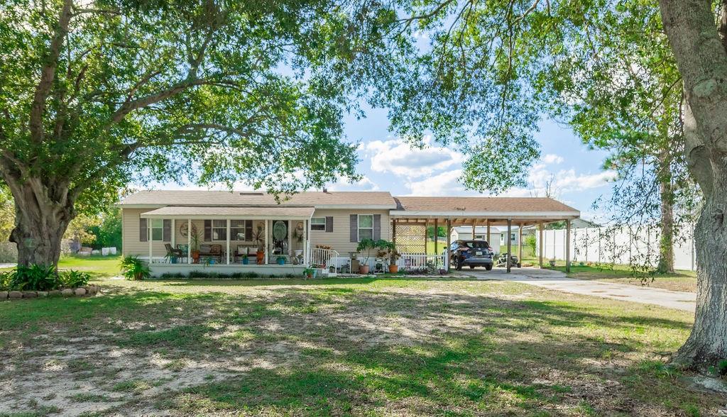 This cozy three-bedroom home on nearly an acre of high dry land offers a spacious front porch shaded by majestic oak trees in a nice country atmosphere yet close to shopping, restaurants and medical needs. Attached to the home is a well-built double carport with space to hangout or have family/friend gatherings. There is also a nice shed for storage and shop space. Located just minutes from downtown Lake Wales with its many festivals and festivities around Lake Wailes or in the beautifully restored streets and parks. Conveniently located an hour from Orlando and Tampa airports and a little further to either of Florida's gorgeous coasts. You don't want to miss this one...call today to schedule a viewing appointment.