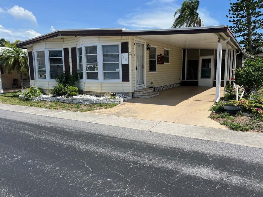 MOTIVATED SELLER...MAKE AN OFFER! Palm Hill Country Club is a greatly valued park due to its resort-style amenities and numerous activities. This locale offers proximity to world-class beaches and the Pinellas Trail for walking and biking. You can choose whether to relax or be incredibly active with swimming pools, jacuzzis, tennis, shuffleboard, billiards, pickleball and more!  This newly listed two-bedroom, two-bathroom home is situated in the widely favored pet section of the park where one small pet, up to 20 lbs., is welcome. It stands out as one of the more substantial floor plans in the park at 1332 sq ft.  Additionally, the monthly maintenance fee of $554.00 covers water, sewer, garbage, lawn service, internet, and cable.
INTERIOR :
Your first impression of this home through the front entrance is sure to impress, as you are greeted by an expansive open living and dining space. This residence is fully furnished and turn-key ready. The front living room features six large windows that flood the area with natural light, making it ideal for entertaining a large group of guests. The dining area is generously sized and includes a built-in china cabinet that offers additional storage and a display area for collectibles. Adjacent to the kitchen is an intimate sitting area currently utilized as an additional television viewing space, but can be adapted for various purposes. There is also a sliding glass door leading to a screened porch. The uniquely designed round kitchen facilitates easy movement and is equipped with modern conveniences, including a dishwasher, microwave, and double stainless-steel sink with a faucet water filter. It also features a breakfast bar, perfect for morning coffee or tea. The master bedroom is impressively spacious, with space for a king-size bed, dresser, desk area, and a separate make-up table. It includes a ceiling fan, generous closet, and an additional walk-in closet. The en suite bathroom features wall cabinets for linen storage and a single vanity with a large mirror. The separate toilet and shower area includes a newer walk-in shower.  The guest bedroom accommodates a queen-size bed, a ceiling fan, and ample closet space. The guest bathroom is spacious, with a single vanity that offers a long countertop and an abundant amount of storage cabinets, along with a shower and tub. 
EXTERIOR:
Upon arriving at this property, you will be greeted by a well-maintained home featuring exquisite landscaping. The house is clad in yellow vinyl siding with front shutters and high-quality cloth awnings surrounding the exterior. The carport leads to the entrance of a screened-in room on a lowered level. This area serves as a comfortable seating space for cooler weather and includes storm shutters for protection against wind and rain. Within this room, there is access to an 8x12 shed equipped with a full-size washer and dryer, additional shelving for storage and an extra refrigerator. A back door from the screened room leads to a tranquil paved patio, ideal for enjoying outdoor relaxation and nature. Privacy is ensured by white vinyl fencing that separates the property from rear neighbors.  Additionally, the home benefits from a new roof over completed in 2022. Priced at $109,500 this home includes a share.  Please contact me today to schedule your private showing.