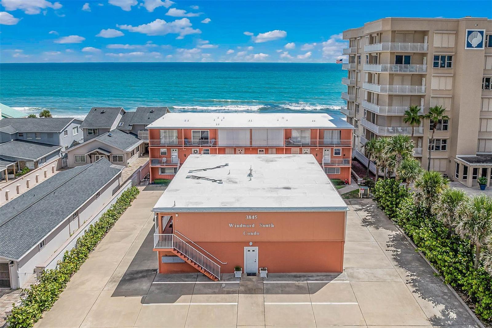 Coastal Comfort - Updated, Upgraded & Steps to the Beach! Remodeled end unit condo in Winward South - 2BR/2BA condo with a 1-car garage, huge screened rear porch featuring an upgraded no-see-um screen (2025), motorized hurricane shutters (2025), and impact windows (2025) for year-round safety and peace of mind. Inside, enjoy engineered hardwood flooring, remodeled kitchen & baths with soft-close cabinets, granite countertops, and stainless steel appliances, plus updated light fixtures, ceiling fans, window treatments, and fresh neutral paint. HVAC 4/2020. Exterior upgrades include a new garage door (2024) and hurricane-rated front, screen, and storage doors (2023). Set in a well-maintained, small community of only 11 units, with recent building improvements including new roof, low fees & strong reserves. Private beach access on a no-drive beach with a shower and steps down to the sand—perfect for full-time living or a vacation getaway. Call to see this one today- don't miss out!