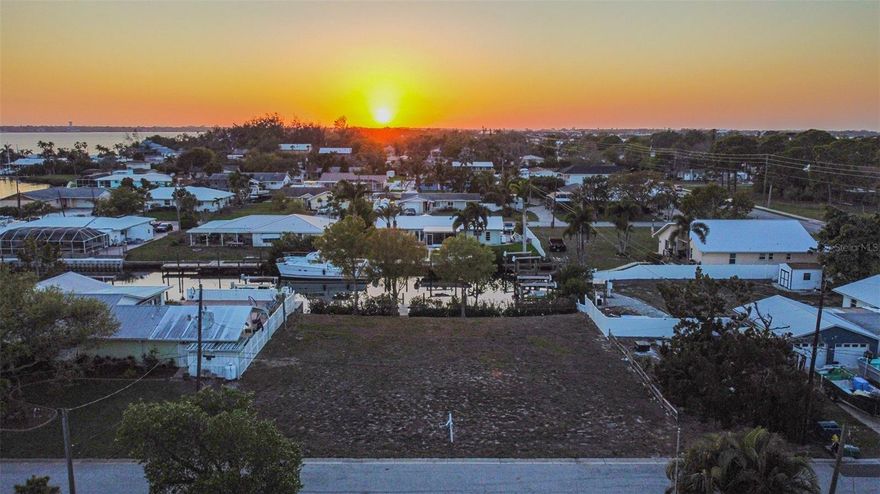 NO BRIDGES TO GULF, NO HOA, SAILBOAT/ DEEP WATER CANAL! FLORIDA PARADISE AND BEAUTIFUL SUNSET VISTAS! Rare opportunity to build on a canal-front homesite in one of Palmetto’s established waterfront neighborhoods. This vacant lot offers direct canal frontage with easy access to the Manatee River and beyond open waters, making it ideal for boating, fishing, kayaking, and enjoying the Florida waterfront lifestyle. Complete with an existing dock in place w/ electricity, making the process of building your dream dock that much easier. Surrounded by existing waterfront homes on a quiet cul-de-sac road, the property provides the perfect setting to design a custom coastal residence. Located just minutes from downtown Palmetto, Snead Island, and Bradenton. The perfect combination of quiet residential waterfront living with proximity to dining, marinas, parks, and major roadways. Electricity is connected and meter is in place. Water connection is easily accessible and readily available. The lot sits within a growing area where canal-front homes command strong demand. Whether you’re a builder, or future homeowner, this property offers a chance to create a custom waterfront retreat in one of Manatee County’s classic boating sceneries.