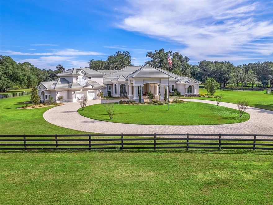 One-of-a-kind exceptional turn-key horse farm with prime location between WEC 1 & the future WEC 2 (Ocala Jockey Club)! This gorgeous 23+ acre equestrian estate on the famous "Millionaires Row" boasts a large main house w/ pool & spa, guest cottage & barn w/ barn apartment! The main house has amazing views from every window of the infinity edge pool & lush grass pastures with mature oak trees. It also has 4 generous bedrooms plus an office & fitness/ 5th bedroom. There are many upscale features including Sub-zero refrigerator & freezer, Wolf appliances & a luxurious master bathroom w/ bedroom-sized walk-in closet. The detached guest cottage is spacious with private laundry, covered parking & extra storage. This well-designed farm features every amenity a top-level equine training facility desires including up to 22 stalls (14-18 stalls in main center aisle barn & 4 other 12' x 14' stalls), comfortable 1 bedroom barn apartment, 2 grooming stalls, feed room, huge tack room with 1/2 bath, laundry & AC, Wordley Martin arena with mirrors, large detached garage/storage building, round pen, numerous wash stalls & 11 large grass paddocks with water & 4 board fencing. This exceptional & private equestrian estate is a must see!