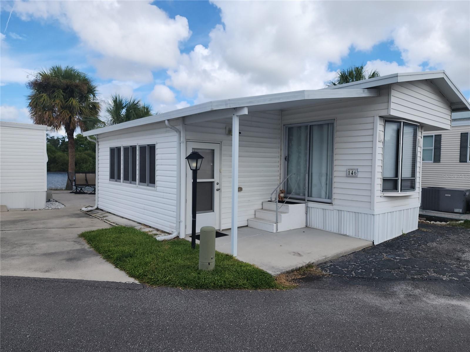 Sarasota Lakes RV is an oasis of resort style living!! The gated community has swimming, tennis, shuffle board, pickle ball and a playground.
This corner lot can be used for personal use or RV rental. Lot has a 1 bedroom 1 bathroom park model manufactured home with addition. Fully
furnished with washer and dryer On site management. Perfect location in Sarasota! Close to beaches and close to St. Armand Circle.