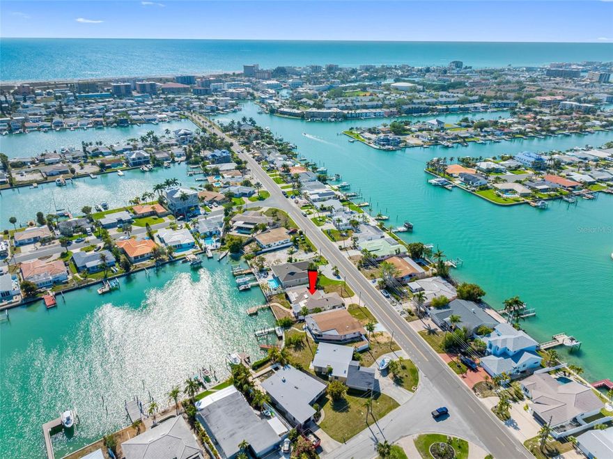 A rare opportunity to own a premier waterfront property on Treasure Island, where breathtaking canal views open directly to the Intracoastal Waterway. This exceptional location offers no fixed bridges to the Gulf of Mexico—perfect for outdoor enthusiasts who will enjoy using the canal for swimming, paddleboarding, kayaking, or boating.  Enjoy effortless access to open water—while still being just a short walk or bike ride to the area’s award-winning white sand beaches. This three-bedroom, two-bath home has been fully remediated and is ready for your vision. Inside, a spacious sunroom expands the living area and showcases stunning water views, creating the perfect setting for relaxing mornings and unforgettable sunsets. Annual fireworks reflect on the water creating magical memories. Step outside to your private waterfront retreat. The composite dock with an expansive seating area is ideal for entertaining, unwinding, or simply taking in the nightly technicolor sunsets that define Florida coastal living. Dolphins, sea turtles, herons and egrets often make surprise appearances. A covered patio offers a comfortable outdoor space for grilling and dining—imagine enjoying fresh fish caught right from your own backyard. Beyond the property, Treasure Island delivers a vibrant yet laid-back coastal lifestyle. Explore locally owned restaurants, charming beach bars, and unique shops, or spend your weekends at the popular Friday markets and lively beachfront festivals. Don’t miss the internationally renowned Sanding Ovations sand sculpting competition, a true highlight of the community. This is more than a home—it’s your gateway to the waterfront lifestyle you’ve been waiting for.