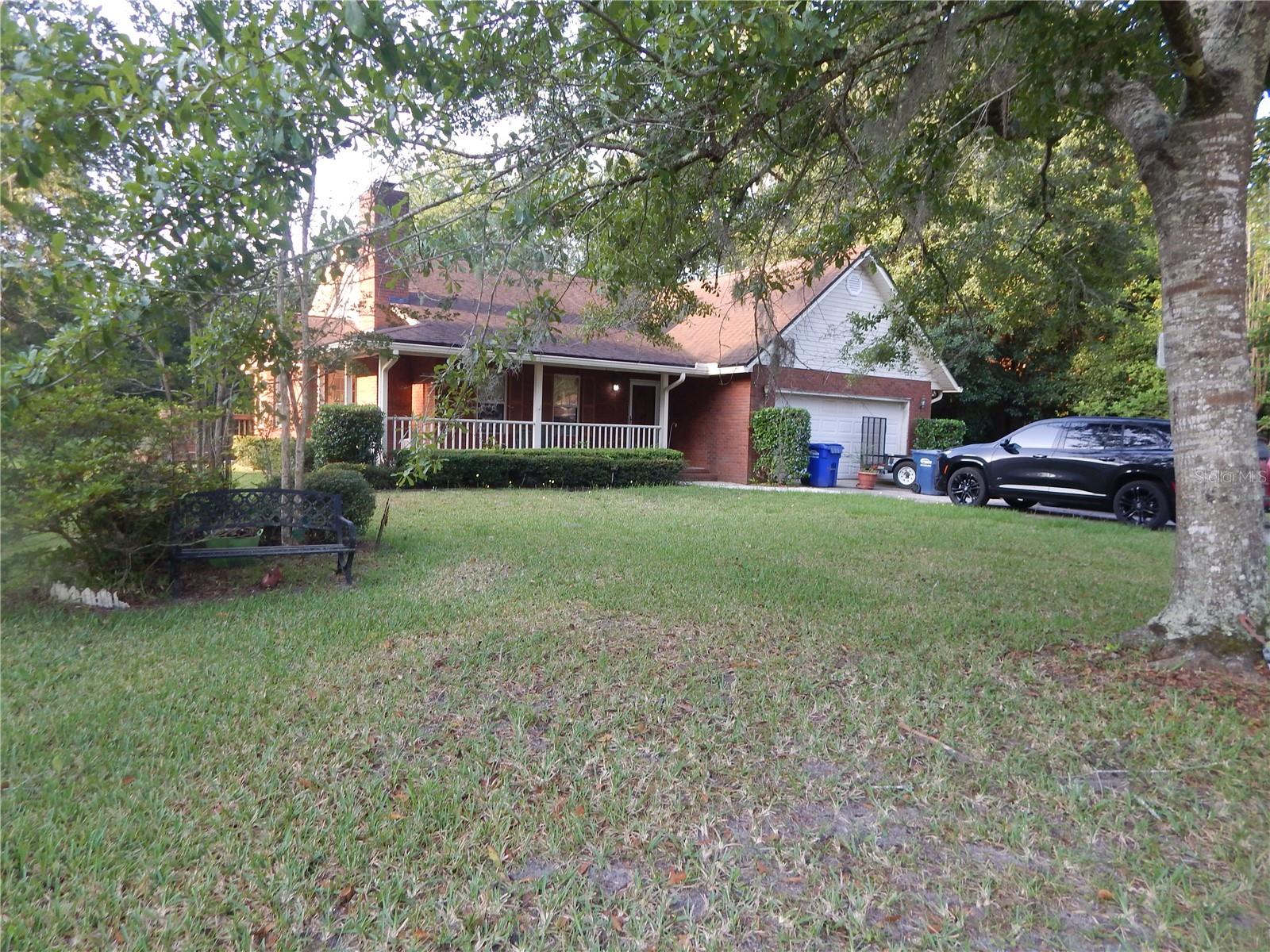 AWESOME! 1,637 sq ft ranch, with a wrap around porch, 2 car garage, CLOSE TO 1 acre, fenced lot, large kitchen with solid oak cabinets, updated counter tops, built in micro, elec range, refrigerator, pantry, dinning room with door leading to porch, large living rm with cathedral ceiling, wood burning, stone, fireplace, large master bedroom with tray ceiling, large master bath with walk in closet, dual vanity sinks, tub, tile stand up shower, ceiling fans thru out, filtration system, irrigation system, and much more. Solid built home, move in ready, quiet established neighborhood, NO HOA. As is