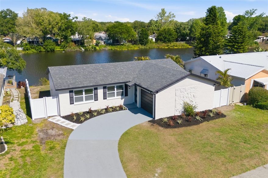 Welcome to this beautifully fully renovated waterfront residence, where modern design meets effortless Florida living. From the moment you arrive, the clean exterior lines, fresh landscaping, and inviting curb appeal set the tone for what awaits inside. Roof 2026, Water Heater 2019, AC 2015.

Step into a bright and open-concept layout featuring wide-plank flooring, abundant natural light, and a seamless flow between living, dining, and kitchen spaces—perfect for both everyday living and entertaining. The designer kitchen is thoughtfully crafted with custom two-tone cabinetry, sleek quartz countertops, stainless steel appliances, and a statement backsplash that adds just the right touch of sophistication.

Enjoy tranquil water views right from your dining area, with sliding glass doors that lead to a private backyard retreat. The newly built deck overlooking the water creates the ideal setting for morning coffee, evening relaxation, or weekend gatherings.

The home continues to impress with tastefully updated bathrooms, including a modern walk-in shower with elegant finishes, and carefully selected fixtures throughout that elevate the entire space.

Every detail has been considered—from the updated systems to the finishes—offering a truly move-in-ready experience.

Conveniently located near major roads, shopping, dining, and everyday amenities, this property combines style, comfort, and location in one exceptional opportunity.

A home that feels as good as it looks—schedule your private showing and experience it for yourself.