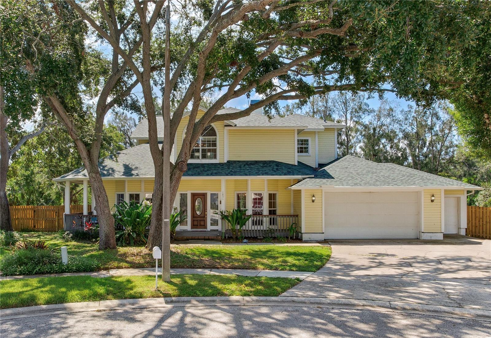 STUNNING 4-BED, 3-BATH POOL HOME ON A PRIVATE CUL-DE-SAC Welcome to 1851 Juanita Ct, a stunning and spacious two-story home tucked away on a quiet cul-de-sac in the heart of Clearwater. This beautifully updated 4-bedroom, 3-bath residence offers over 2,800 square feet of living space and is perfectly designed for comfort, style, and entertaining. Set on an oversized lot with no rear neighbors and surrounded by mature trees, the home provides rare privacy and a peaceful natural backdrop. Step inside to find soaring ceilings, wood-look flooring throughout, and abundant natural light that highlights every detail. The open-concept layout features a formal living room and dining area with elegant lighting. The fully renovated kitchen is a true showpiece, equipped with soft-close shaker cabinetry, granite countertops, stainless steel appliances, double ovens, a designer backsplash, and a large center island. The sunny breakfast nook overlooks the expansive backyard and sparkling pool, creating a perfect setting for morning coffee or casual dining. The first floor also includes a full guest bedroom and bathroom, ideal for a home office or in-law suite, as well as multiple living areas and a well-appointed laundry room with custom cabinetry. Upstairs, the luxurious primary suite impresses with vaulted ceilings, triple bay windows, a sitting area, and private French doors that lead to a large covered balcony with serene views of the trees and water beyond. The primary bath offers a spa-like experience with a jetted tub, custom tile walk-in shower with a expansive walk-in closet. Two additional bedrooms upstairs share access to the wraparound balcony and feature ample closet space and sliders. The home’s thoughtful layout also includes a bonus flex room and an oversized three-car garage with additional storage space. Outdoors, the fully fenced backyard is a private oasis with a generous pool deck, lush lawn, and direct views of the creek an a peaceful wooded preserve. This home combines exceptional value with unmatched character and functionality. Located just minutes from Clearwater Beach, downtown Dunedin, top-rated schools, shopping, and dining, 1851 Juanita Ct is truly a rare find and move-in ready.