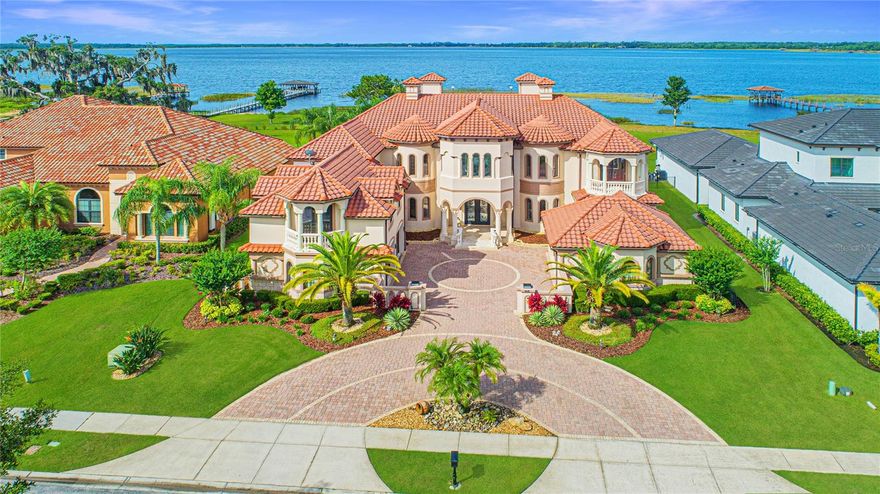 GATED, LAKEFRONT, POOL in Moss Park Reserve! VERY energy efficient home including construction with ICF block. It’s rare to find a home that stops you in your tracks. One that is jaw-dropping, breathtaking, and completely amazing.This home is sure to exceed even your wildest dreams. While the home is the property’s crown jewel, the grounds create awe. A brick paver circular driveway winds up to the home with split 2-car garages to store all your cars, boats and water toys. Positioned on a .66 home site and surrounded by lush, mature landscaping including palm trees, fenced for privacy with multiple covered patios, balconies and an expansive pool deck all overlooking the sparkling lake. Arriving here will feel like a fairytale, as the grand foyer with floating double spiral staircases welcomes you into the 9,272-square-foot home. Artfully created with every luxury and detail in mind, this home encompasses 6 bedrooms, 7 full bathrooms and 1 half bathrooms. Your fantasy comes to life as this masterpiece captivates you at every turn. A two-story ceiling, fireplace and oversized Palladian windows grace the living room, maximizing natural light and making formal gatherings intimate and cozy. Exceptional living spaces including the formal dining room featuring a butler’s pantry pass through great for private dinners. Architectural beauty is found in every room with elegant finishes, including stone columns, travertine and hardwood floors, hand-crafted ceiling detail, crown molding and custom wall treatments. The open concept kitchen is beautiful and functional and dazzles with granite countertops, decorative trim cabinetry, marble backsplash, Miele and Sub-Zero appliances including double ovens, a gas stove with griddle and pot filler, a separate storage pantry, and an oversized island with 360-degree storage, and a wine vault. The kitchen and adjoining breakfast and family rooms open to an impressive outdoor covered dining and entertaining space, perfect for enjoying a morning cup of coffee while enjoying the beautifully appointed outdoor spaces. The expansive owners' quarters, spread across the entire south wing of the property with direct access to the pool and deck, boasts a full menu of luxury features including a gym, sitting room, oversized boutique-style closets with custom shelving, and a spa-like bathroom with stand-alone tub, separate shower with rainfall shower head and double sinks with makeup vanity in the center. Upstairs entertainment is highlighted by a home theater, spacious game room with a bar that opens onto a covered balcony overlooking breathtaking water views. An office plus many flex rooms wind in and out of the amazing space. Four additional bedrooms including a master suite complete the second floor all with access to a balcony or open deck. Laundry rooms on both levels. Outside, an oversized, covered lanai with a summer kitchen and multi-seating areas complement an open-air pool/spa, creating a relaxing retreat where you can unwind and soak up Florida's sunshine. Designed around the natural outdoor beauty and spectacular setting this property is very special. Minutes to Medical City, schools, shopping, dining, everything is close by that you will need. Make your appointment today! One year basic home warranty provided.