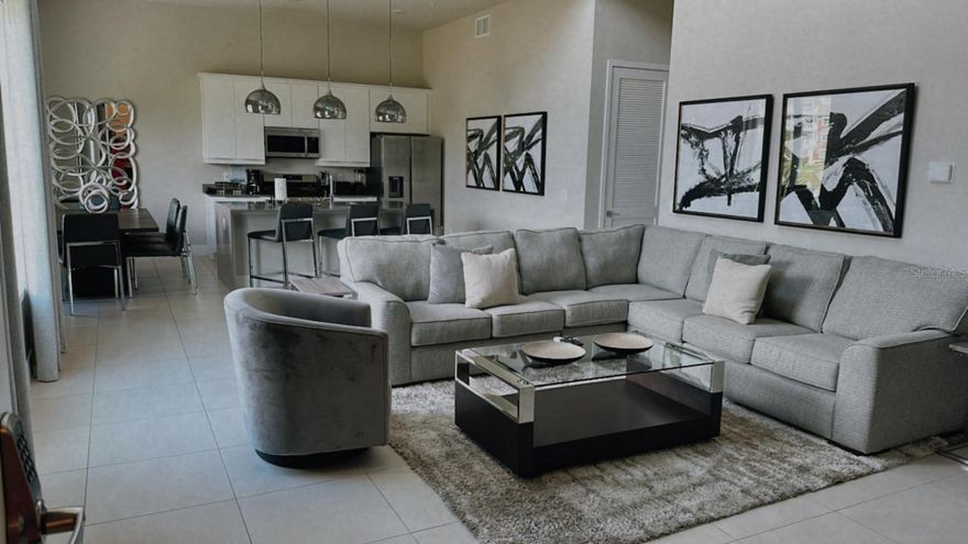 Discover luxury living at its finest in this stunning 5-bedroom, 4-bathroom vacation condo located in the exclusive Spectrum+ at Reunion Resort. Perfectly situated to unparalleled access to the entertainment, shopping, and world-class golf courses in the greater Orlando area, this property is an ideal addition to your portfolio. The expansive floor plan provides ample space for relaxation and entertainment. With a modern, open-concept design, the living area flows seamlessly into a gourmet kitchen equipped with high-end appliances and plenty of cabinetry. Each of the five bedrooms is a serene retreat, featuring large windows that flood the rooms with natural light. The primary bedroom on the first floor boasts a luxurious en-suite bathroom with dual vanities, a walk-in shower, and a private water closet. Upstairs, the loft/flex space leads to an expansive outdoor area with stunning views, perfect for al fresco dining or unwinding after a day of fun. This level also includes an additional bedroom and bathroom, offering extra privacy and comfort for guests. The on-site amenities resort amenities include a clubhouse with a game room and concierge services, ensuring all your needs are met, a state-of-the-art fitness center, resort-style pool with cabanas, a fantastic kiddie waterpark, miniature golf and an internal golf-cart transportation service. Choose from six resort restaurants, relax at any of the ten community pools, or take advantage of the complimentary transportation to Walt Disney World and around the Kissimmee area. Just 10 minutes to Disney and 30 minutes to Orlando International Airport, this condo is perfectly positioned for both convenience and excitement. Whether you’re seeking a relaxing retreat or an action-packed adventure. From its ease of maintenance to a highly-desirable location and unrivaled amenities, this luxury vacation condo represents the perfect blend of comfort and convenience. Don’t miss out on this incredible opportunity to own a piece of paradise in the heart of Orlando!