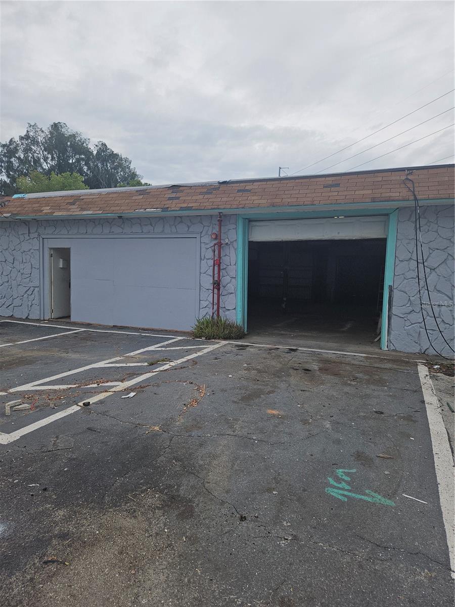 Unlock the potential of this versatile C-2 zoned property, perfect for a wide range of uses. The 1742 Sq Ft of total lease space includes an expansive 1545 sq. ft. garage including a built-in paint booth, making it ideal for automotive, storage, or creative work. A separate 81.2 sq. ft. office with its own entrance adds convenience for business operations or administrative needs, while the 116 sq. ft. covered exterior carport provides additional functionality. Featuring two 10-ft garage doors—front and rear access—this space offers maximum flexibility and ease of use. Water and electricity are included, making it a turnkey solution for storage, personal workspace, or a potential approved business venture. Contact the listing agent today to for details.