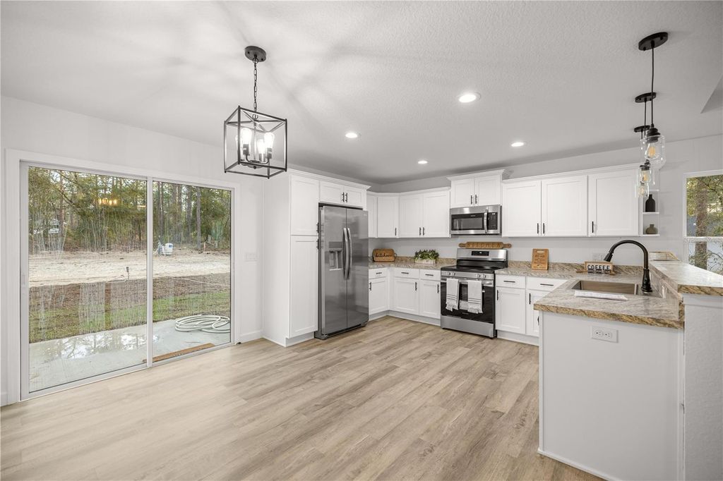 Photo of 24242 NW Aspen Lane, Dunnellon, FL 34431 (MLS # OM719136)