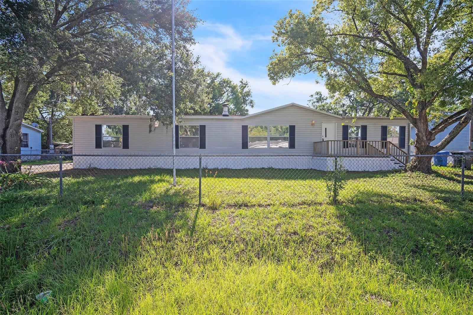 This beautiful 4 bed 2 bath hom is nestled on a spacious nearly 1/4-acre lot in the heart of Tampa. Enjoy the freedom of no HOA and peace of mind with no flood zone designation! This 1,782 square foot home offers several recent upgrades, including a 2021 AC unit, brand new well pump and pressure tank, and a fresh coat of paint inside and out, making it move-in ready. The interior features an indoor laundry room for added convenience, while outside you’ll find a covered back deck, perfect for relaxing or entertaining. Additional highlights include new skirting, a huge shed/workshop ideal for hobbies or projects, plus a second shed for extra storage. Whether you're a first-time buyer, investor, or looking to downsize without sacrificing outdoor space, this property has it all. Don't miss this opportunity to own a well-maintained home with room to grow, play, and create. Come see this home today, you'll love what it has to offer!