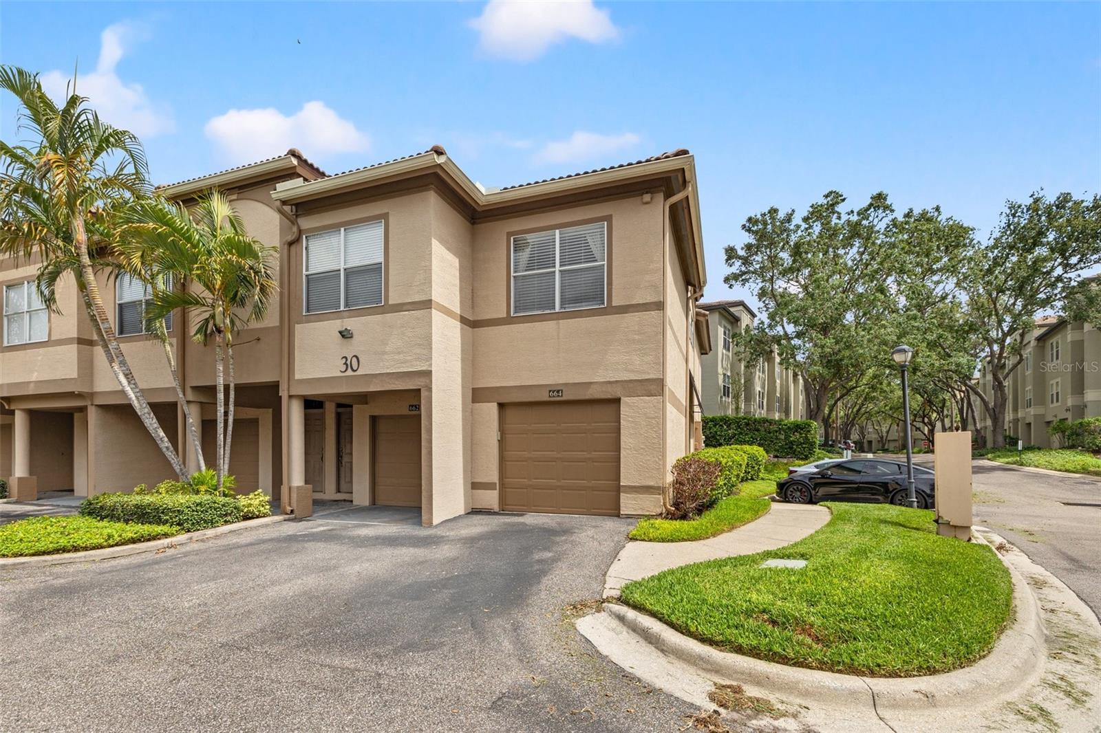 One or more photo(s) has been virtually staged. Beautifully updated 3 bedroom, 2 bathroom corner unit condo offering nearly 1,500 sq. ft. of single-level living in the sought-after Island Walk community on Harbour Island. Publically available for sale for the first time in nearly 20 years. Perfectly positioned in the heart of downtown Tampa, this property blends serene living with the energy of city life just outside your door. Step inside to find gleaming travertine floors throughout the main living areas, complemented by brand-new interior paint that enhances the bright, open feel. The split-bedroom layout provides privacy and comfort, while the spacious primary suite and guest bedrooms are ideal for family or visiting guests. The kitchen is equipped with Frigidaire stainless steel appliances, and the condo includes a full-size interior laundry room for added convenience. Relax on your screened and covered patio, where tranquil views create the perfect backdrop for morning coffee or evening unwinding. Additional highlights include a 1-car garage, barrel tile roof, and first-floor, all-one-level living. Island Walk offers 24-hour guard-gated security, a sparkling community pool, fitness center, and onsite management. The seller has paid the Island Walk assessment in full. Enjoy unmatched convenience with walkable access to Downtown Tampa, Water Street, Sparkman Wharf, and the area’s best restaurants, shops, and entertainment — all while living in a quiet, beautifully landscaped setting.