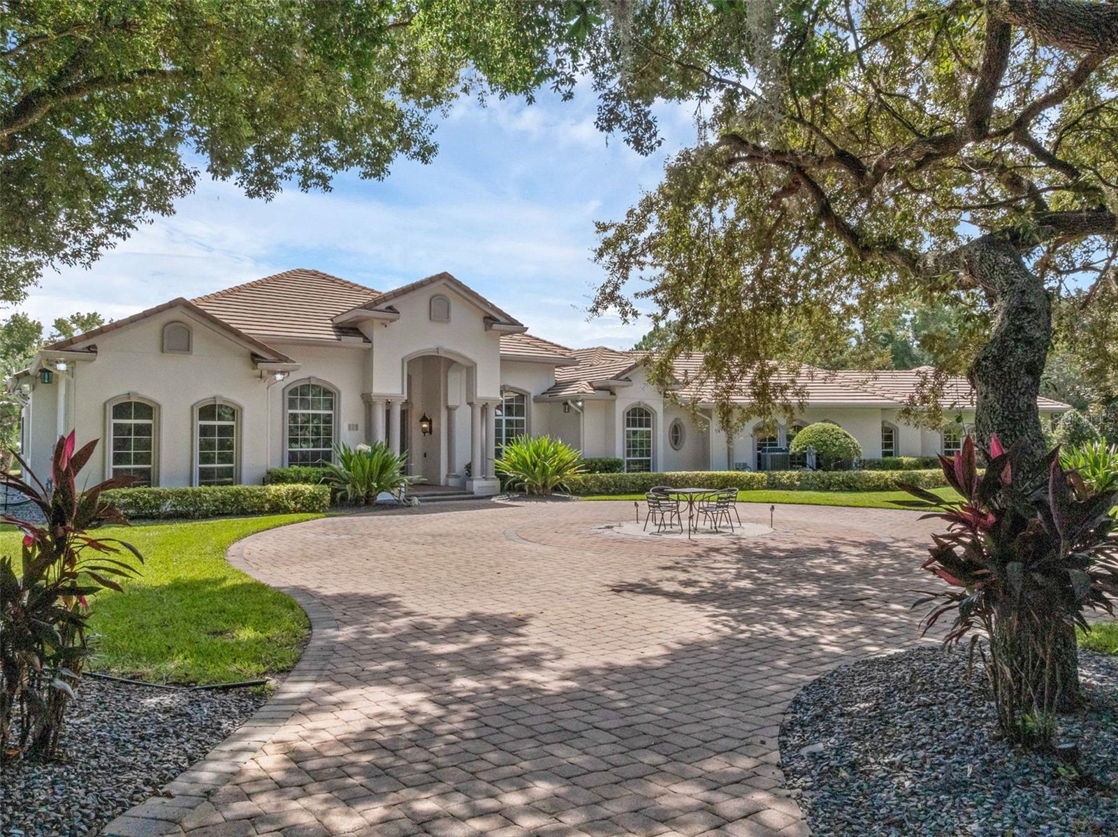 Live the Heathrow Lifestyle—Without the HOA!
Welcome to one of the most extraordinary custom-built estate homes in the heart of the Lake Mary/Heathrow area. This rare opportunity offers the prestige of Heathrow living without the fees, tucked away in a private, park-like setting just steps from International Parkway and Colonial Town Park.
Boasting an impressive 12,842 total square feet, this estate is designed for those who demand space, privacy, and unforgettable features. Car collectors and recreation enthusiasts will fall in love with the “Garage Mahal”, providing the ultimate showcase and storage space for all your toys.
The lushly landscaped grounds set the stage for resort-style living. A tropical oasis awaits in the backyard, where a rock waterfall pool and expansive lanai create the perfect retreat. Entertain year-round in style with a full-size Thermador outdoor kitchen, built for hosting family and friends.
Inside, luxury continues with a state-of-the-art private home theater, valued at $400,000, that rivals and outperforms commercial cinemas. Whether it’s movie night, game day, or family gatherings, this one-of-a-kind feature takes entertainment to the next level.
With its unmatched size, design, and amenities, this “Home Extraordinaire” is truly one of the most unique estates available on the market today. Don’t miss your chance to own a property that blends lifestyle, location, and luxury in one remarkable package.